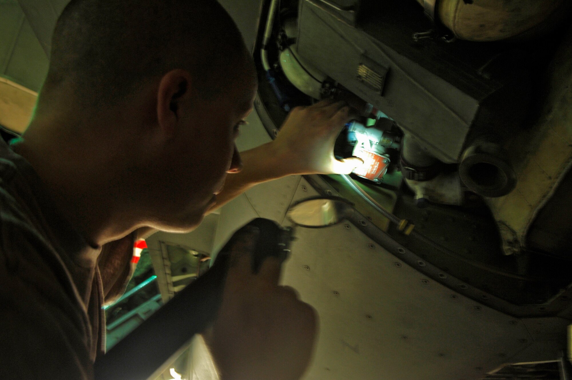 Staff Sgt. Daniel Crane takes a look inside one of the panels of an F-16 Fighting Falcon at Balad Air Base, Iraq, April 19. Maintainers like Sergeant Crane have helped the Air Force generate 1 million sorties, operational flying missions, since the start of the war on terrorism. Sergeant Crane is a 332nd Aircraft Maintenance Squadron phase section floor chief. (U.S. Air Force photo/Staff Sgt. Mareshah Haynes)