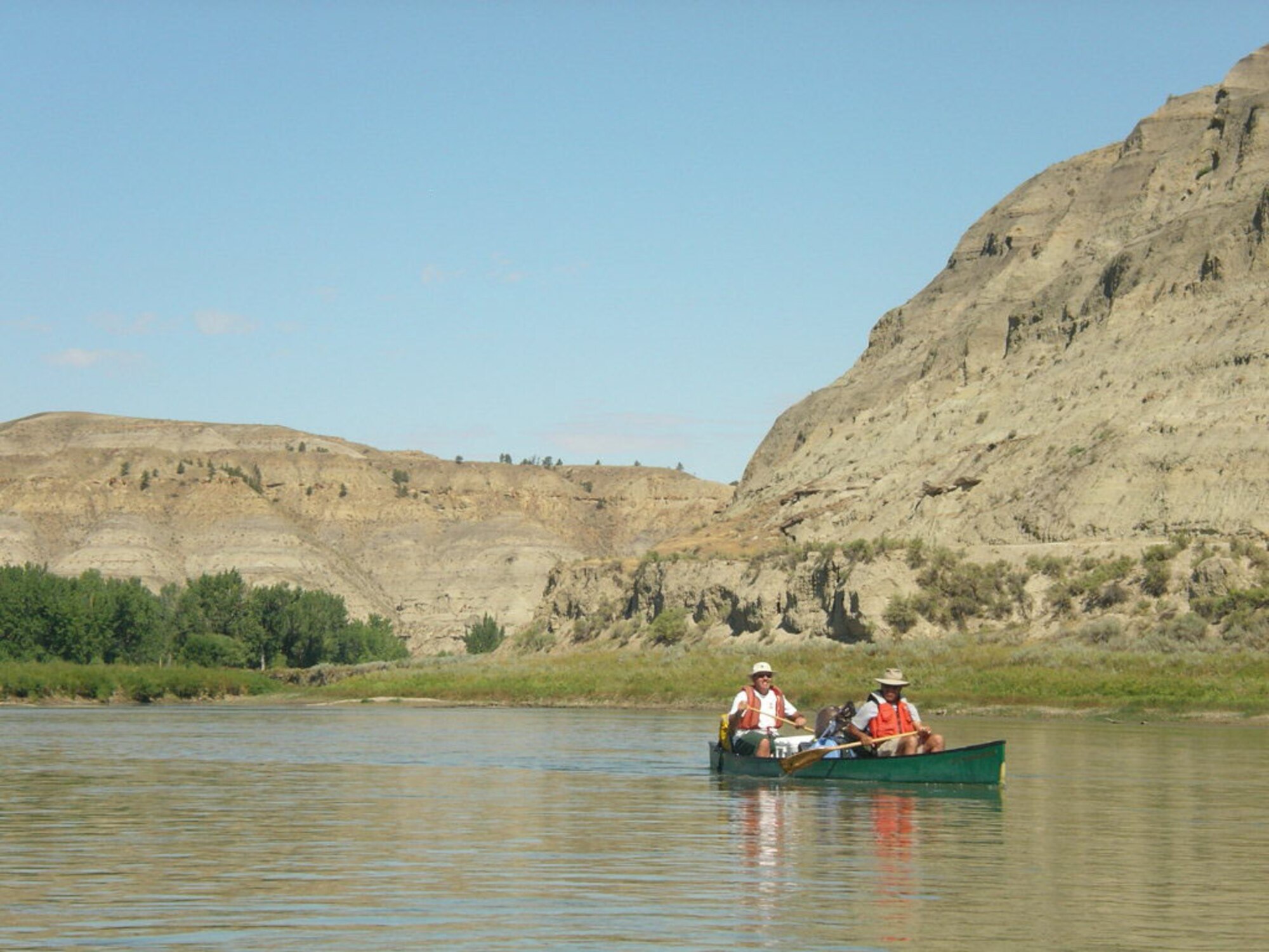 Chief Master Sgt. Larry Wilson (back) and Col. Steve Asher (front) paddle down the Missouri River near Fort Benton, Mont., while performing river patrol duties as volunteers for the Bureau of Land Management. (Courtesy photo)