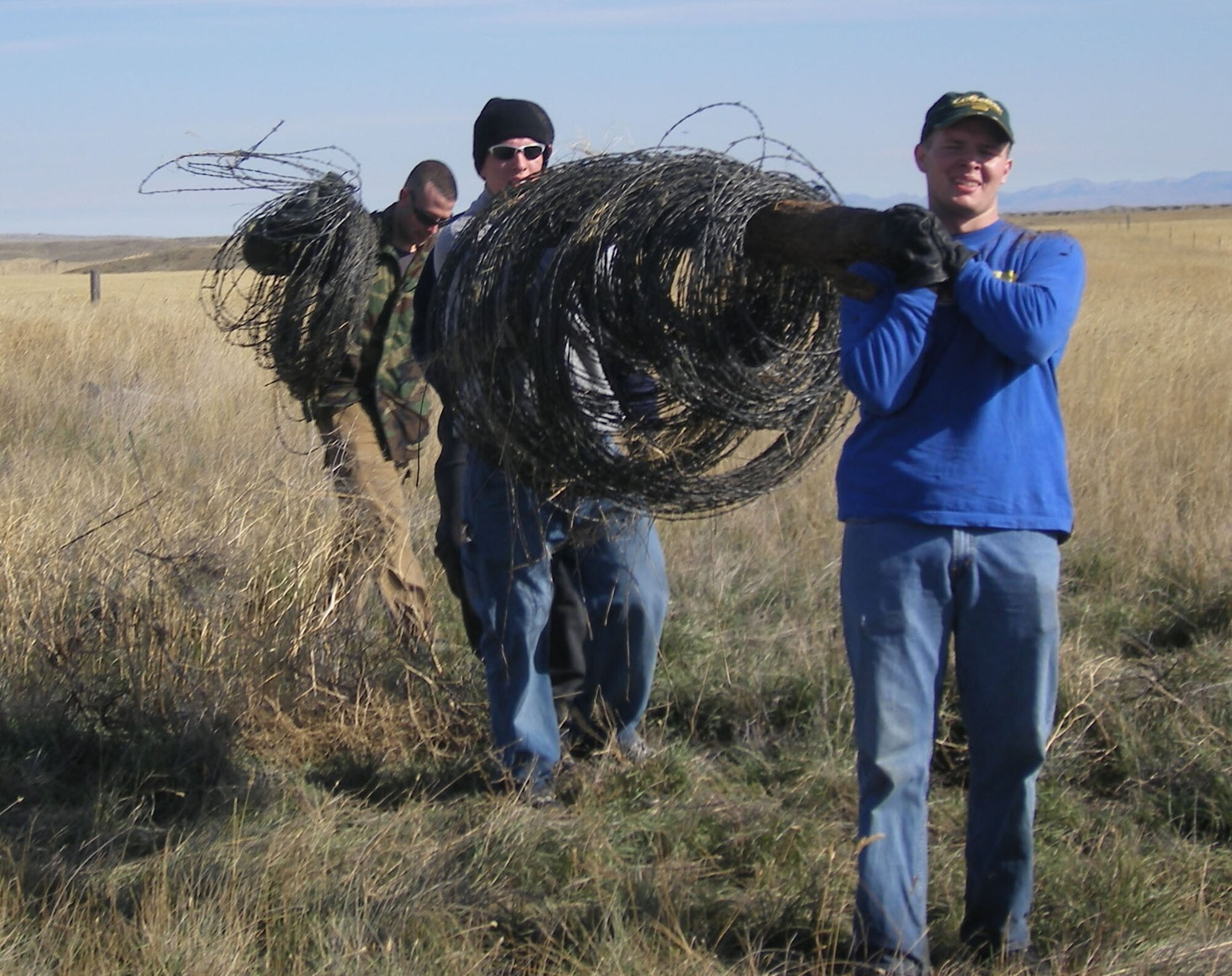 Members of the 341st Security Forces Group team up to tear down and remove unwanted fencing on Bureau of Land Management property near Fort Benton. For this, and otehr volunteer efforts by the SFG Airmen, the BLM nominated them for a national award, which they won. (Courtesy photo)