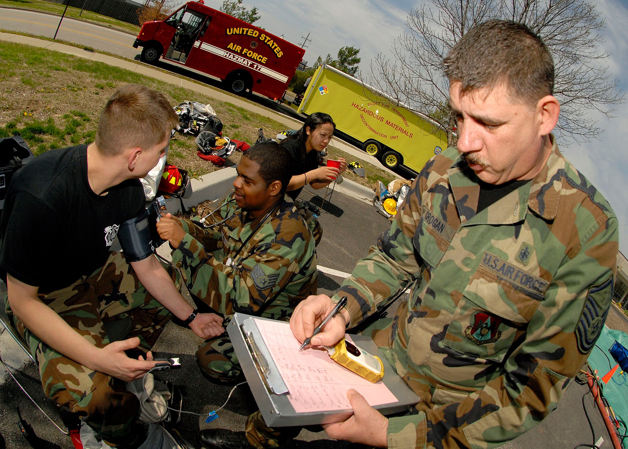 SCOTT AIR FORCE BASE, Ill. -- Master Sgt. Keith Grogan and Staff Sgt. Edric Johnson, 375th Airlift Wing Medical Group, participate in the exercise by taking vital signs of anyone who has gone through simulated decontamination. The exercise included three suspicious packages positioned around the base. (U.S. Air Force photo/Airman 1st Class Megan Gilliland)