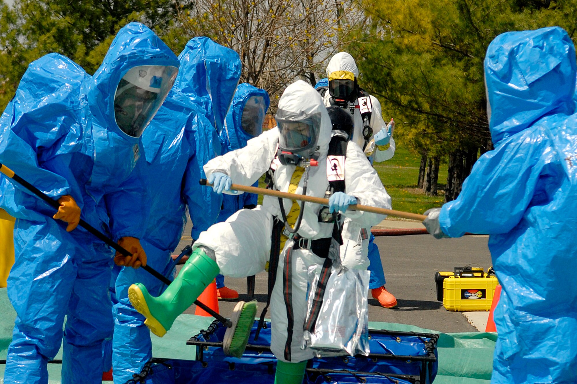 SCOTT AIR FORCE BASE, Ill. -- Members of 375th Civil Engineer squadron wear hazardous material suits and walk through a decontamination line during an exercise at Scott Air Force Base April 17. The exercise included three suspicious packages positioned around the base. (U.S. Air Force photo/Airman 1st Class Megan Gilliland)
