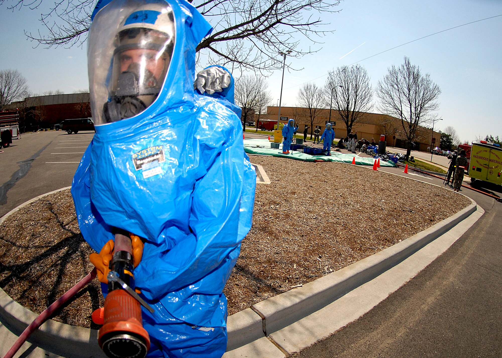 SCOTT AIR FORCE BASE, Ill. -- Members of the 375th Airlift Wing Civil Engineer squadron prepare to use their hose during an exercise at Scott Air Force Base April 17. The exercise included three suspicious packages positioned around the base. (U.S. Air Force photo/Airman 1st Class Megan Gilliland)