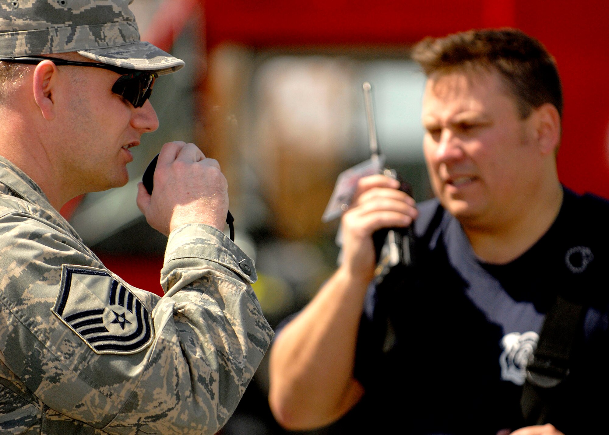 SCOTT AIR FORCE BASE, Ill. -- Emergency response teams communicate during the exercise at the Post Office at Scott Air Force Base April 17. The exercise included three suspicious packages positioned around the base. (U.S. Air Force photo/Airman 1st Class Megan Gilliland)