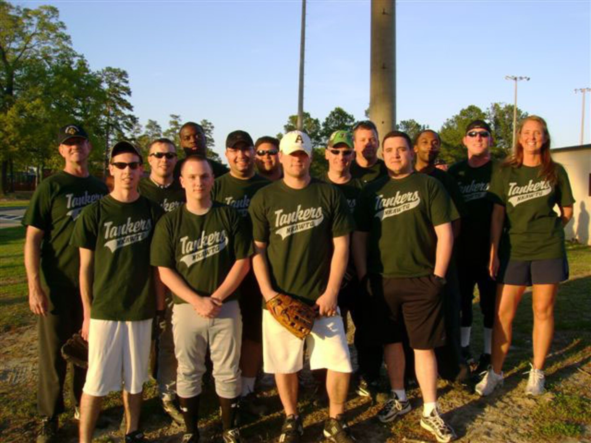SEYMOUR JOHNSON AIR FORCE BASE, N.C. -- Team Tanker is ready to play! Reservists from the 916th Air Refueling Wing pose for a picture prior to their softball game on April 17.  More than 30 members of the wing and active duty members from the 911th Air Refueling Squadron play twice a week on Tuesdays and Thursdays against various teams comprised of squadron members from the 4th Fighter Wing. The season began just a few weeks ago and so far Team Tanker is having a lot of fun. They are coached by Master Sgt. Laura Gebert and the coach says they are always looking for players, but really need some enthusiastic fans to support them at their games on-base each week.