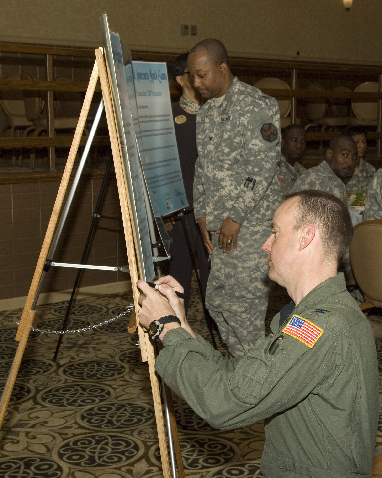 Col. Michael Polhemus, 305th Air Mobility Wing director of staff, signs the Installation Commander’s 2008 Sexual Assault Policy on behalf of Col. Balan Ayyar, 305th AMW commander, at the Sexual Assault Awareness Month luncheon held at Club Dix April 16. April is Sexual Assault Awareness Month. U.S. Air Force photo/Kenn Mann.
