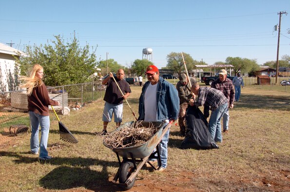 ALTUS AIR FORCE BASE, Okla. -- Airmen from the 97th Logistics Readiness Squadron Aerial Operations Flight cleans up the 519 West Hardy lot, in Altus, Okla., recently. Aerial Ops is in its third year of their volunteer service commitment in support of Habitat for Humanity. All supplies and equipment used to maintain the lot are supplied by the Airmen. (U.S. Air Force photo/Airman 1st Class Marianne Lane)