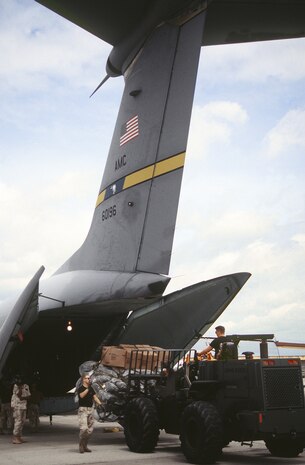 An aerial port specialist offloads a cargo pallet from a Charleston AFB C-141 Starlifter at Moi International Airport. The 437th Airlift Wing, together with the Reserve associate wing, the 315th Airlift Wing, provides a large part of Air Mobility Command's Global Reach airlift capability. (U.S. Air Force photo/Senior Airman Andy Dunaway)