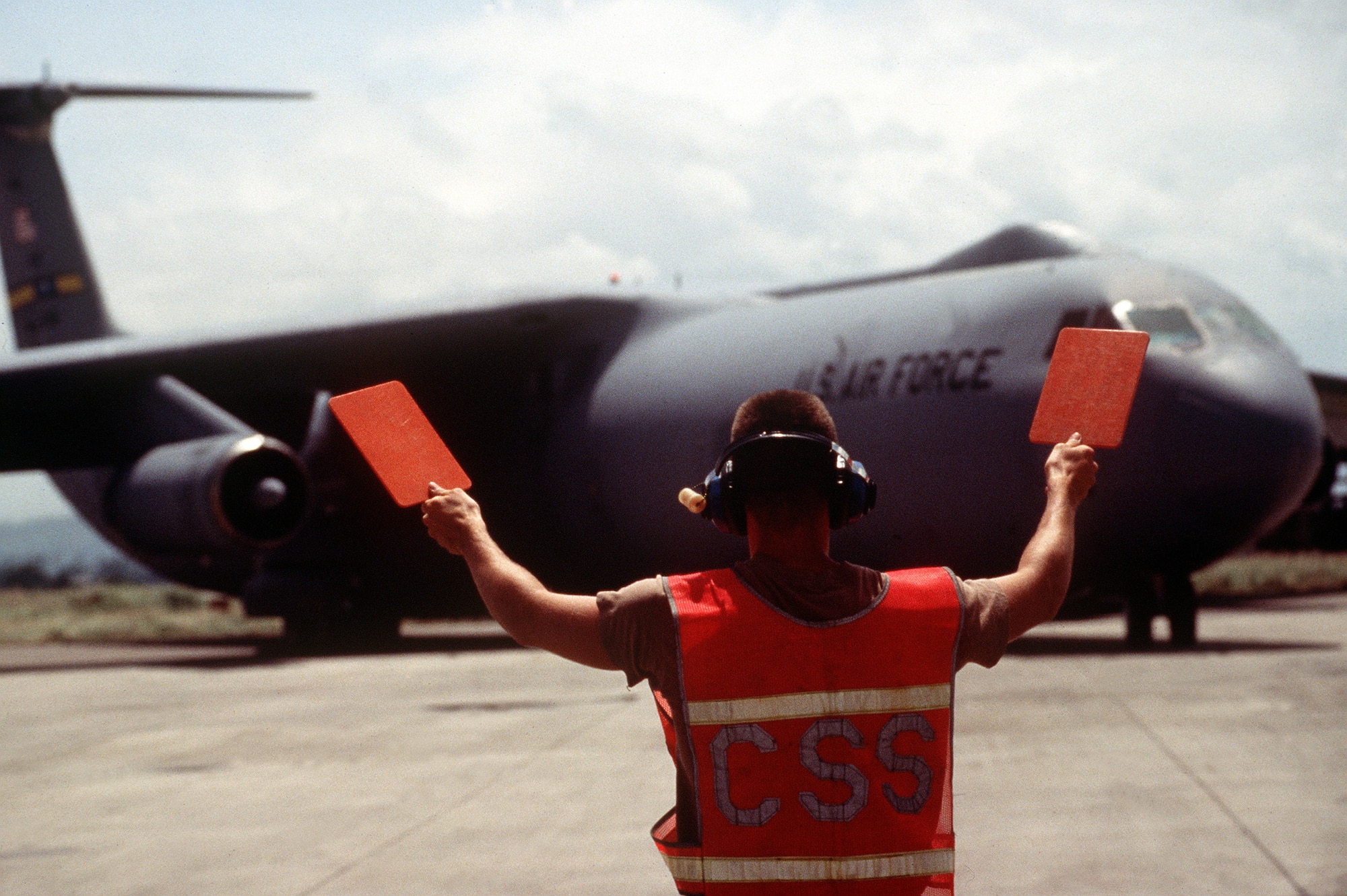 A ground crewman marshals in a Charleston AFB C-141 Starlifter at Moi International Airport during Operation Support Hope in 1994. Charleston AFB has operated various strategic airlift aircraft since the 1950s, to include the C-124 Globemaster, C-5 Galaxy, C-141 Starlifter and C-17 Globemaster III. (U.S. Air Force photo/Senior Airman Andy Dunaway)