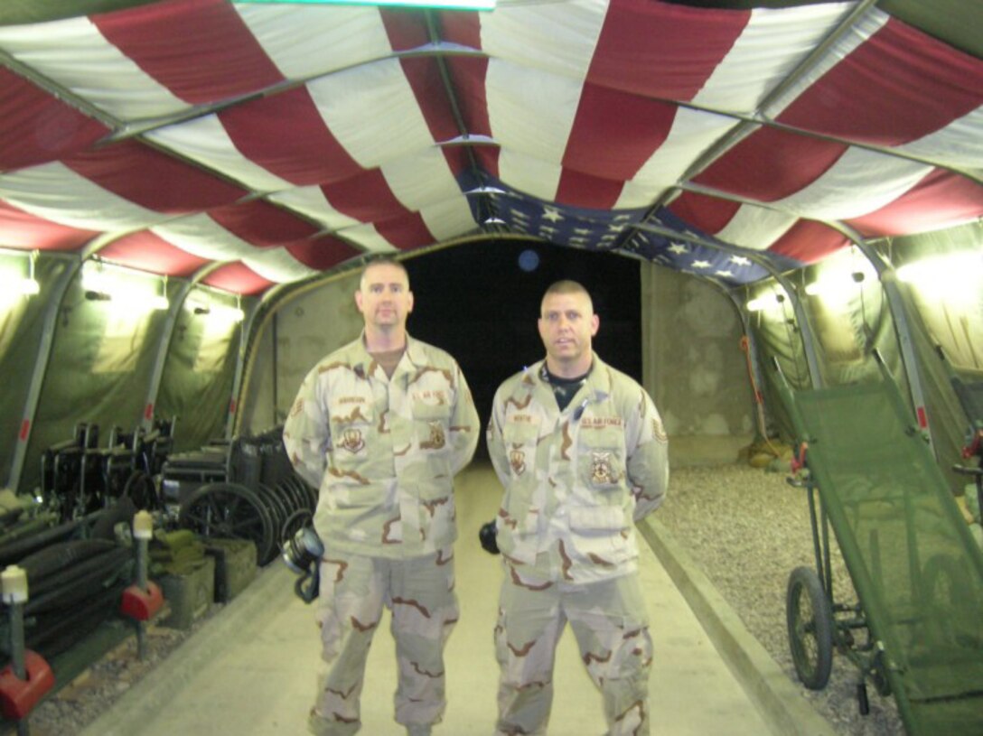 SEYMOUR JOHNSON AIR FORCE BASE, N.C. -- Tech. Sgt. Brad Robinson (right) and Tech. Sgt. Mike Wenthe stand on the Heroes HIghway in Balad. The Heroes Highway is where injured military members are brought for treatment. Sgt. Robinson and Sgt. Wenthe volunteer their time here when not on duty as firefighters. Both reservists are members of the 916th Civil Engineer Squadron.