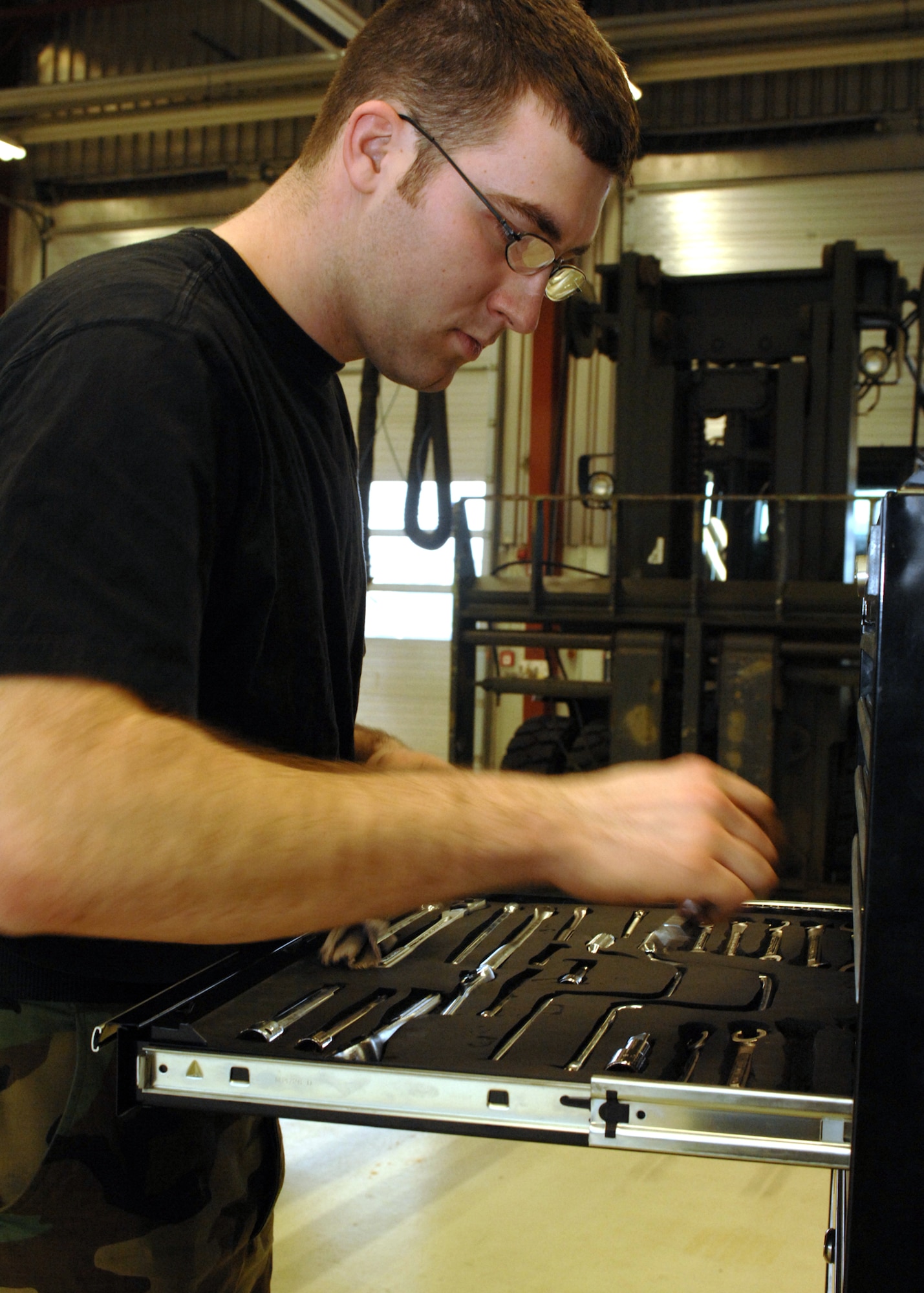 SPANGDAHLEM AIR BASE, Germany --Airman 1st Class Christopher Boze, 52nd Logistics Readiness Squadron, takes care of his tools after working on a vehicle at the vehicle maintenance shop April 14, 2008.  (U.S Air Force photo/Airman 1st Class Jenifer Calhoun)