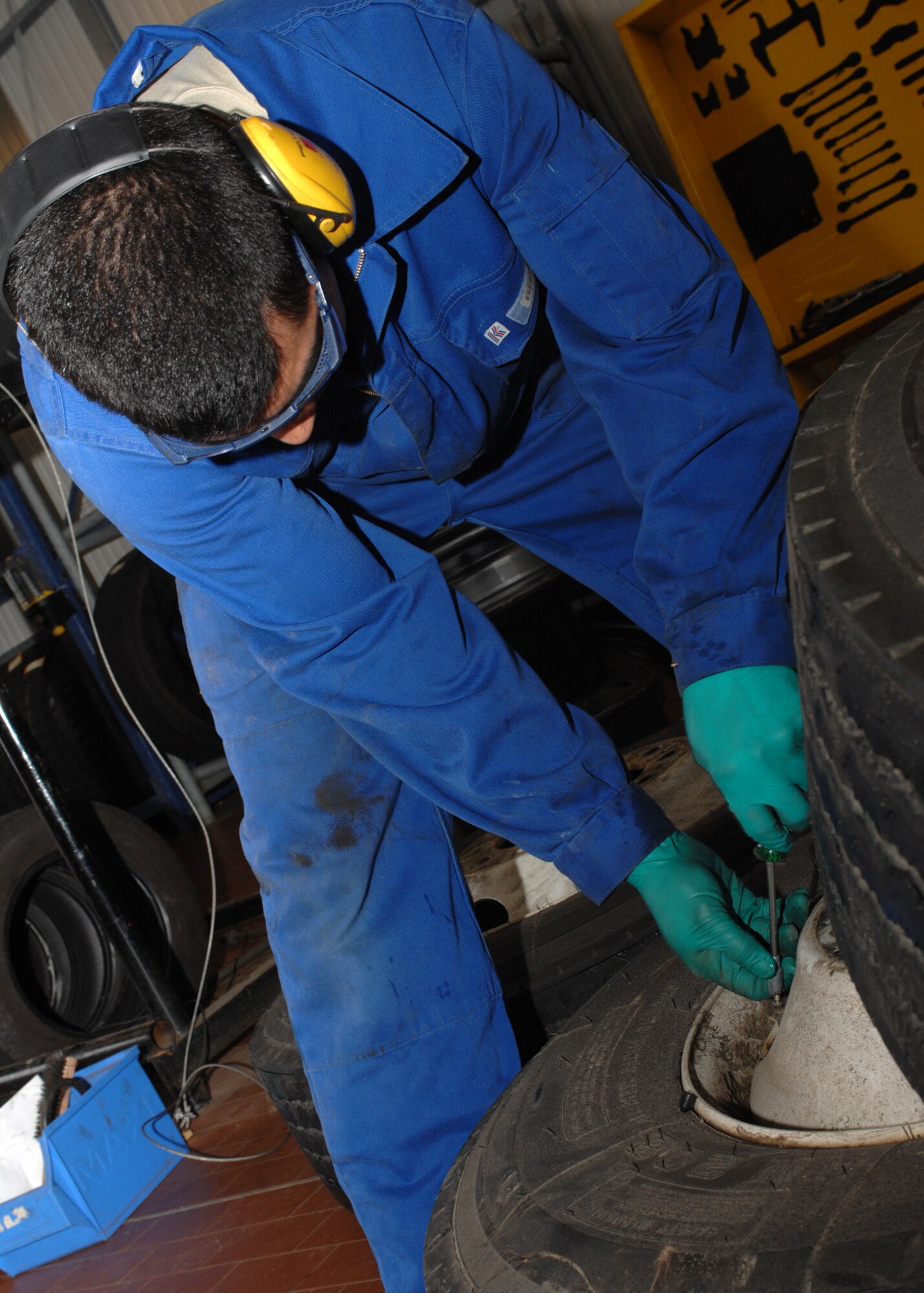 SPANGDAHLEM AIR BASE, Germany -- Airman 1st Class Adrian Cortez, 52nd Logistics Readiness Squadron, releases air from a tire at the vehicle maintenance shop April 14, 2008. Airman Cortez releases the pressure so he can change the tire. (U.S Air Force photo/Airman 1st Class Jenifer Calhoun)