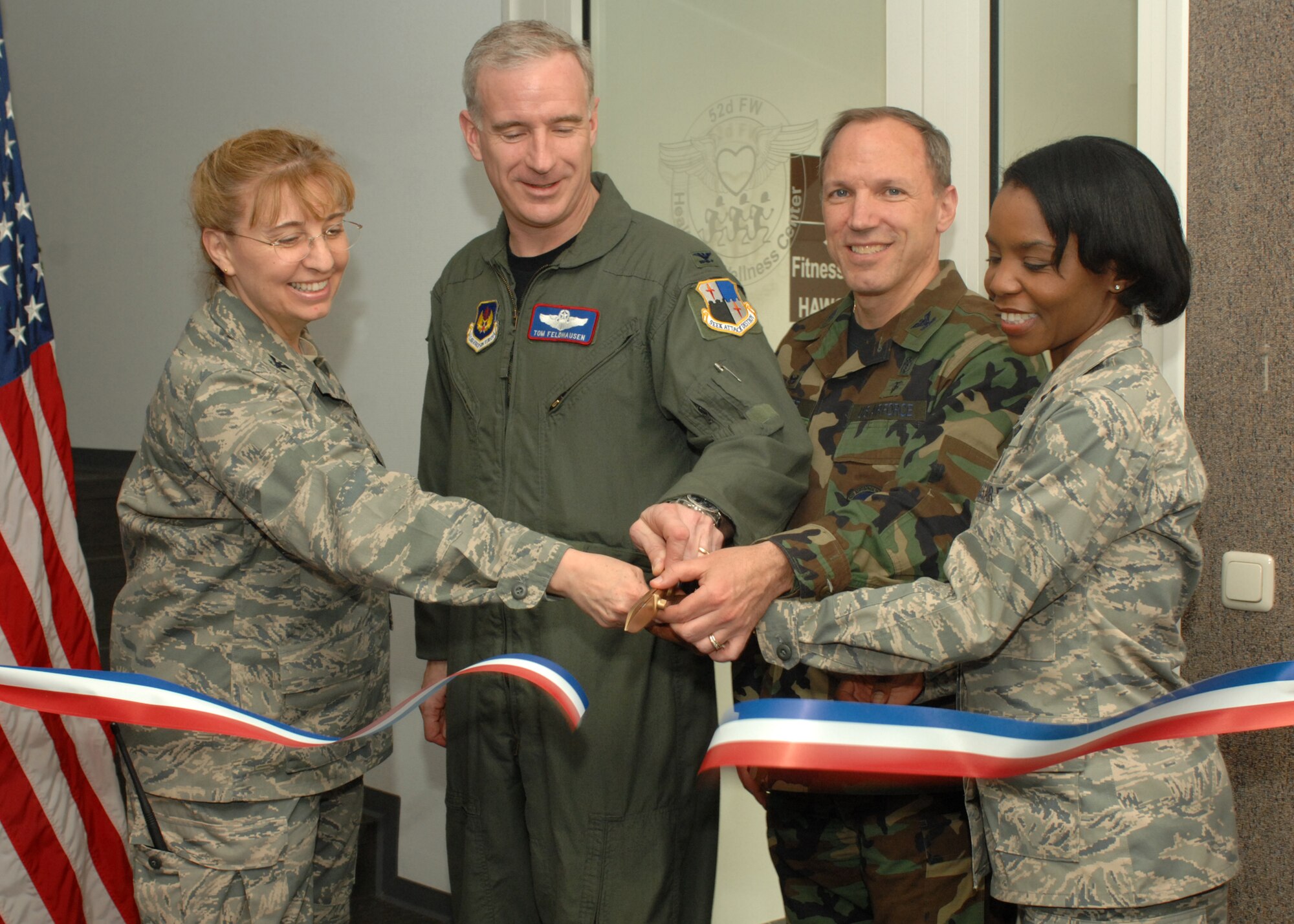 SPANGDAHLEM AIR BASE, Germany -- (Left to Right) Col. Lorrie Cappellino, 52nd Medical Group commander, Col. Thomas Feldhausen, 52nd Fighter Wing commander, Col. Parker Plante, 52nd Aerospace Medicine Squadron commander, and Capt. Sarah Evans, 52nd AMDS, celebrate as the ribbon is finally cut to the newly renovated Health and Wellness Center now located in the Skelton Fitness Center April 21, 2008.  (U.S. Air Force photo/Airman 1st Class Jenifer Calhoun)