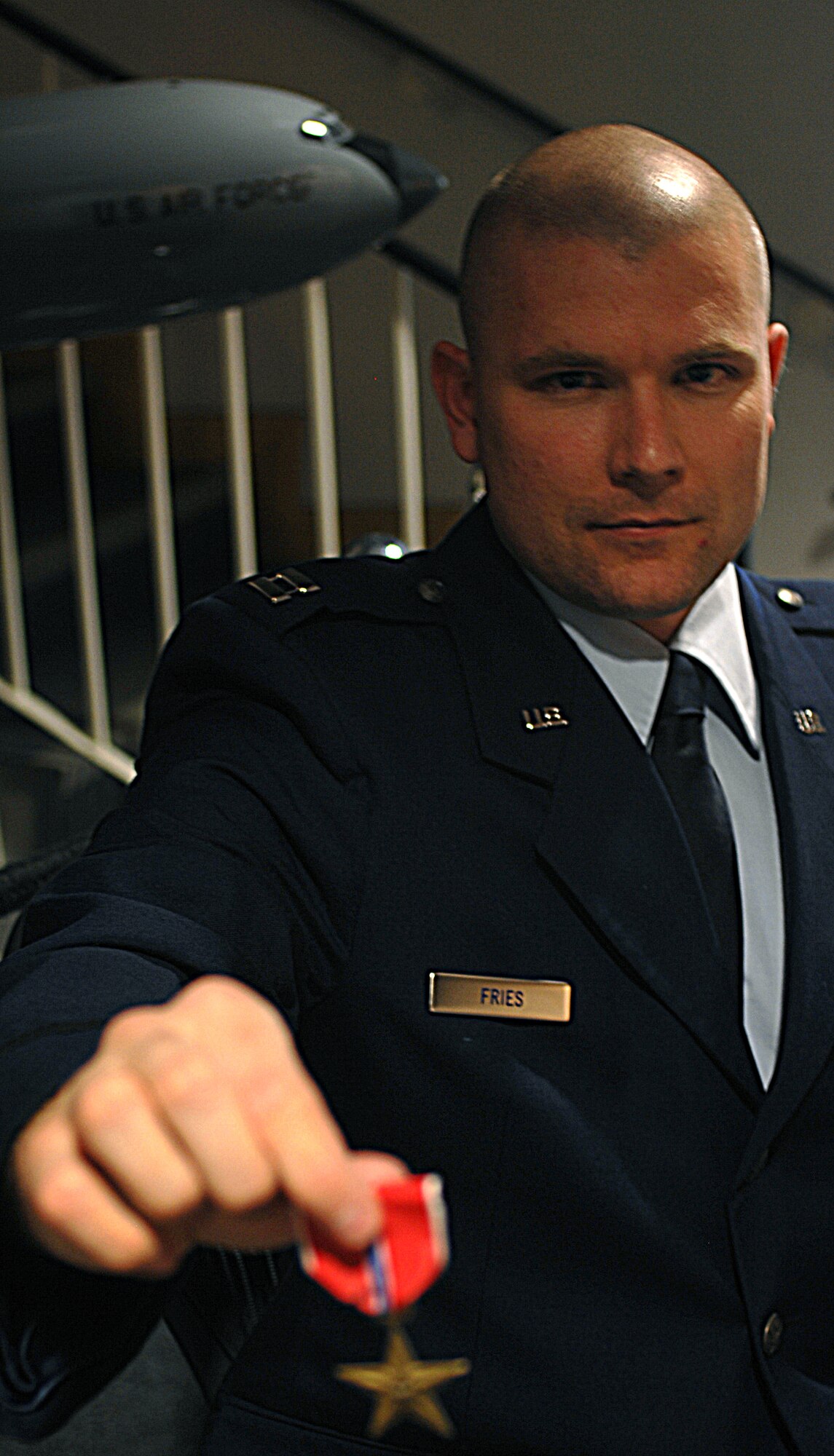 Capt. Jeffrey Fries, 100th Operations Support Squadron Intelligence Flight, holds the bronze star medal he was presented April 18. The captain earned the medal for his work as a senior analyst for a joint task force in support of Iraqi Freedom from May 21 to Nov. 21, 2007. According to the citation, "Capt. Fries' unparalleled expertise, sound judgement, initiative, and leadership allowed him to flawlessly support the task force during sustained combat operation in support of the Global War on Terrorism. His contributions ensured the success of a series of ground combat operations of national significance." (U.S. Air Force photo by Master Sgt. Sarah Frankenhoff)