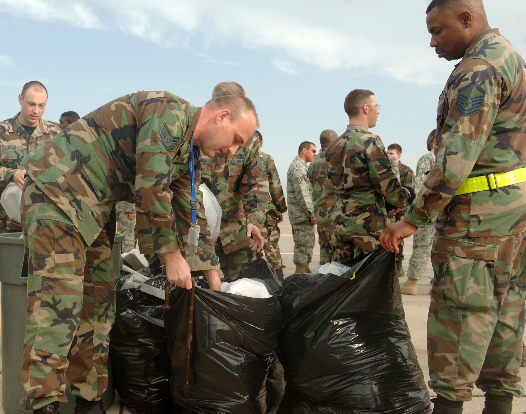 Tech. Sgt. Robert Kozlowski (left), 39th Air Base Wing Flight Safety noncommissioned officer, inspects trash following Incirlik’s April 18 foreign object damage sweep while Master Sgt. Mark Pindell, 39th Maintenance Group quality assurance superintendent and wing foreign object damage monitor, looks on. Approximately 900 Airmen participated in the event and collected more than 353 pounds of debris. (U.S. Air Force photo by Tech. Sgt. Ray Bowden)