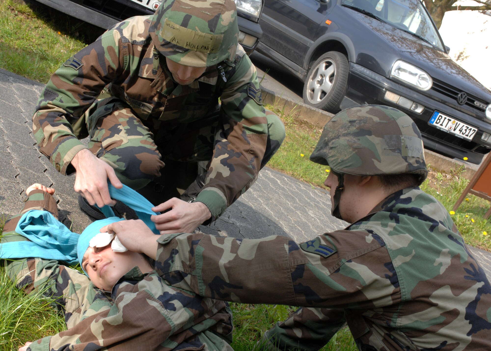SPANGDAHLEM AIR BASE, Germany- Airman 1st Class Johnathan Hollander and Airman 1st Class Justin Holmes, both from the 52nd Maintenance Operations Squadron, assist a victim during the base wide exercise Operation Saber Crown 08-06 April 22, 2008. (U.S. Air Force photo/Airman 1st Class Jenifer Calhoun)