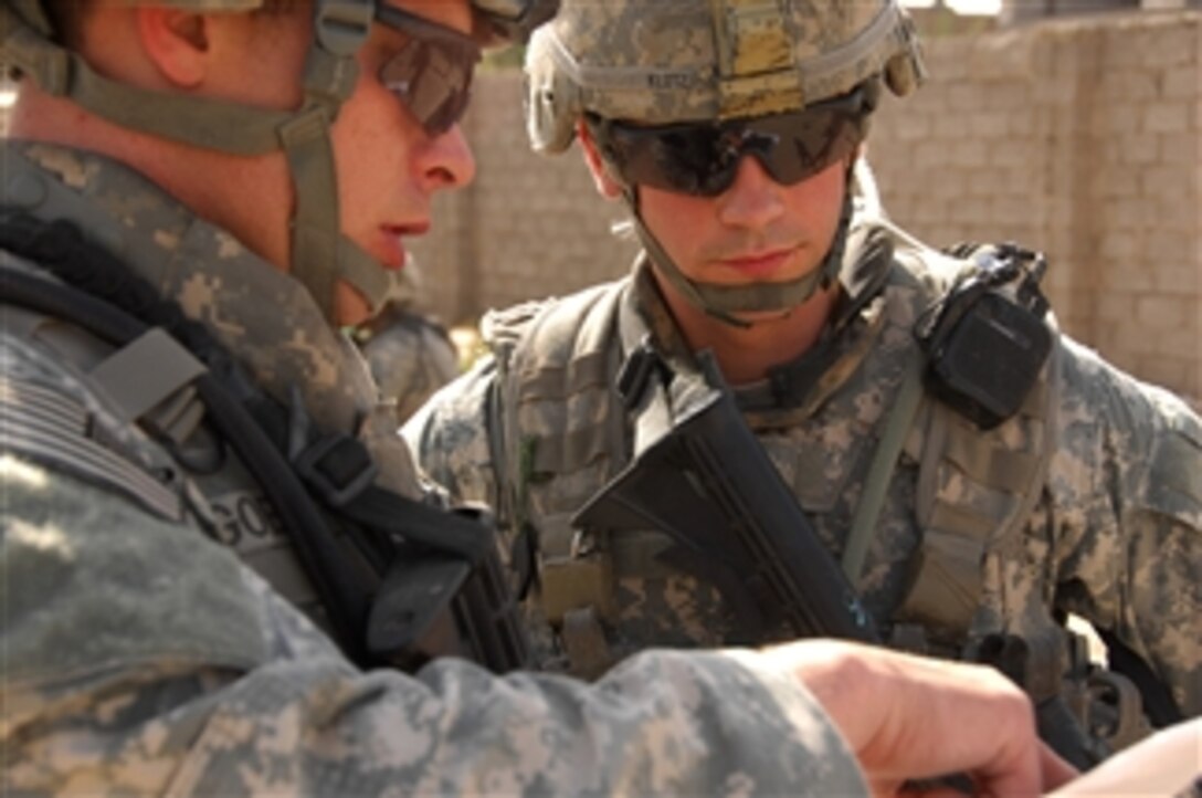 U.S. Army Staff Sgt. Terry Goble (left) briefs Sgt. Robert Klotz prior to a joint patrol through a neighborhood in Shulla, Iraq, on April 3, 2008.  Goble and Klotz are both assigned to 2nd Platoon, Bravo Company, 1st Battalion, 502nd Infantry Regiment, 2nd Brigade Combat Team, 101st Airborne Division.  