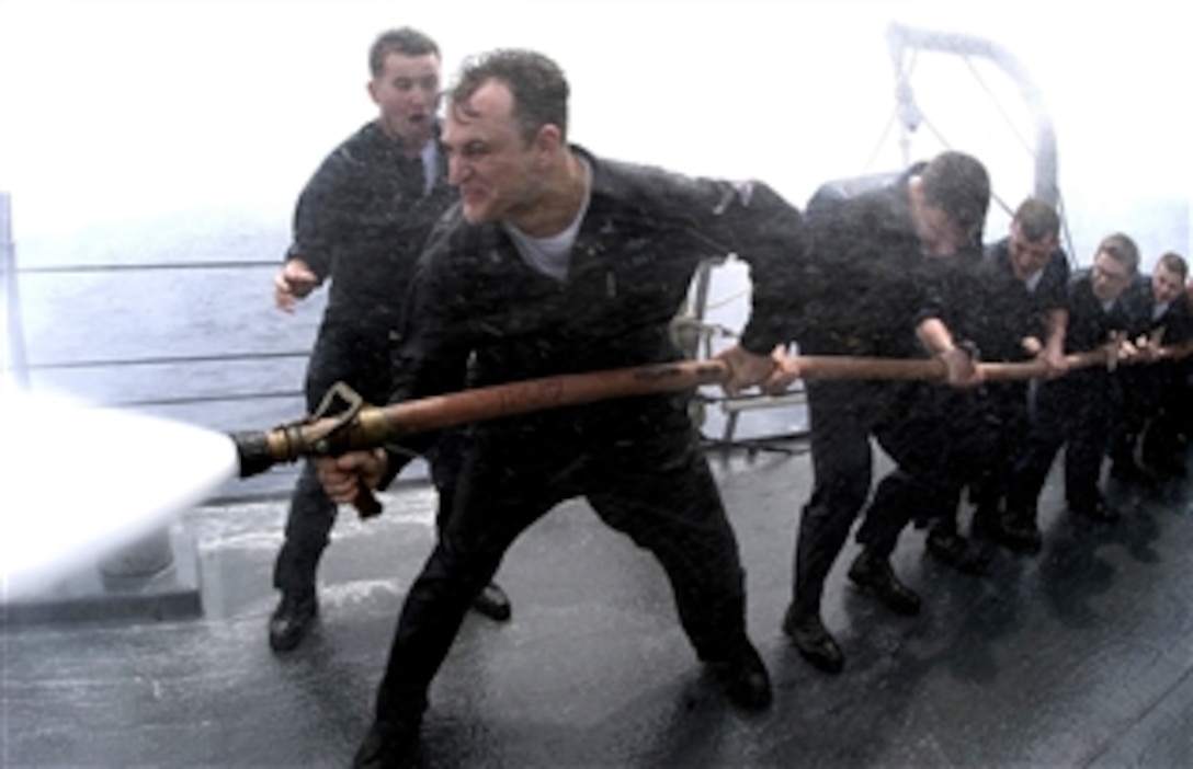 U.S. Navy Seaman Christopher Tornay, a damage controlman fireman, shouts commands at Petty Officer 2nd Class Bryan Egolf during fire hose training on the forecastle of the guided-missile destroyer USS Lassen in the Pacific Ocean, April 21, 2008. 