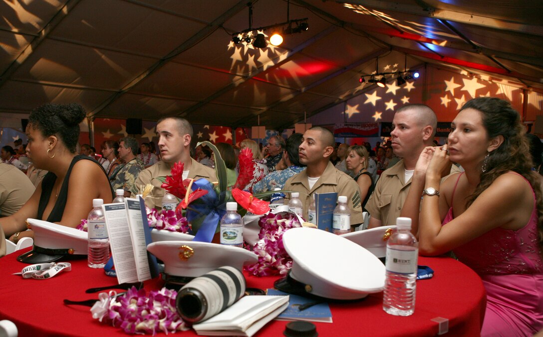 HONOLULU --  Marines and spouses listen as the Hawaii Pacific University International Vocal Ensemble light up the stage in song during the opening ceremony for Hawaii Military Appreciation Month held at the USS Missouri here, April 24.