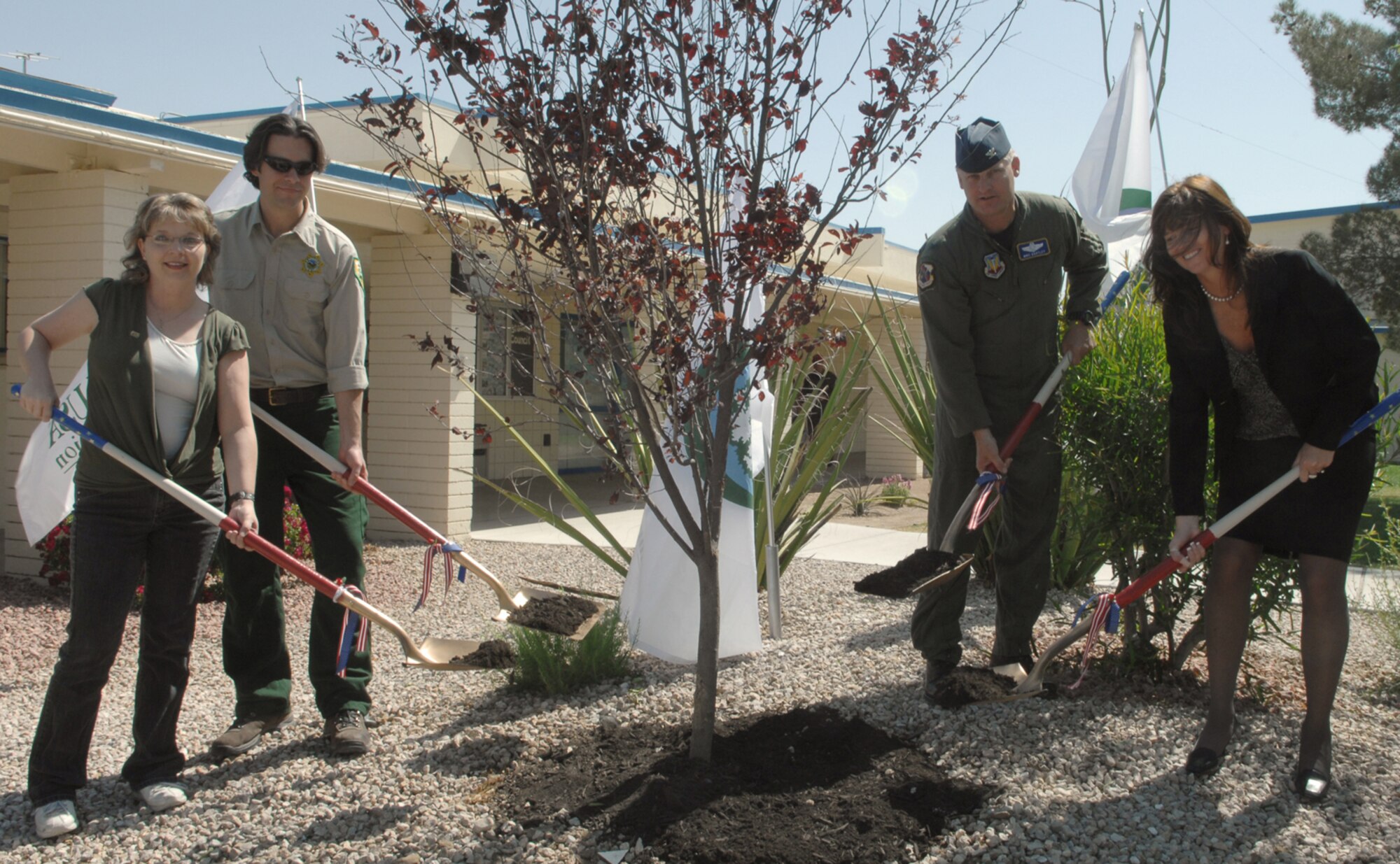 NELLIS AIR FORCE BASE, Nev. -- Shelly Polillo, Parents and Teachers Association President, Matthew Koepnick, National Arbor Day Foundation, Col. Michael Bartley, 99th Air Base Wing commander, and Traci Dyer, Lomie Heard principal, plant a tree in the Lomie Heard Desert Habitat courtyard in celebration of Earth and Arbor days, April 23.  Nellis Air Force Base was honored by the National Arbor Day Foundation's "Tree City USA" for its efforts to improve the base community as well as the greater Las Vegas area.
(U.S. Air Force Photo by Senior Airman Nadine Y. Barclay)