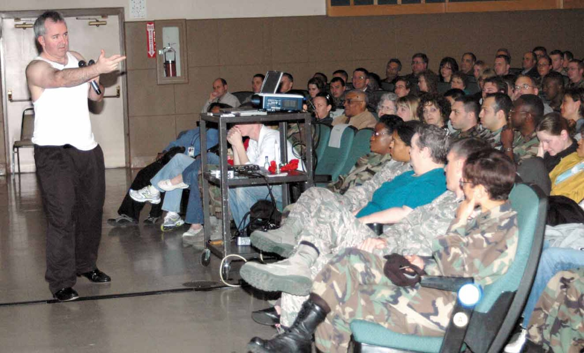 Ben Atherton-Zeman is shown performing his “Rocky” character to a standing room only audience atthe base theater on April 18 where he presented his one man play. The play used humor and several male celebrity voice impressions to bring topics of domestic violence and sexual assault to audiencesin a way that minimizes male defensiveness. The goal of the play is to help men come to the realization
that they are both part of the problem and part of the solution.  (Air Force photo by Danielle Gregory)