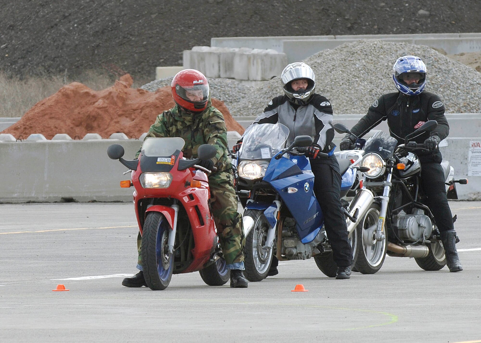 FAIRCHILD AIR FORCE BASE, Wash. – Master Sgt. Steven Stephens, 92nd Air Maintenance Squadron production supervisor, Senior Airman Chelsey Johnson, 92nd Air Refueling Squadron boom operator, and Sergeant Peter Rainbolt, 92nd Security Forces Squadron flight sergeant, waits for further instruction from sports bike instructors on April 22. Members are attending the week long instructor sports bike training to become instructors in later classes. (U.S. Air Force photo / Staff Sergeant JT May III)