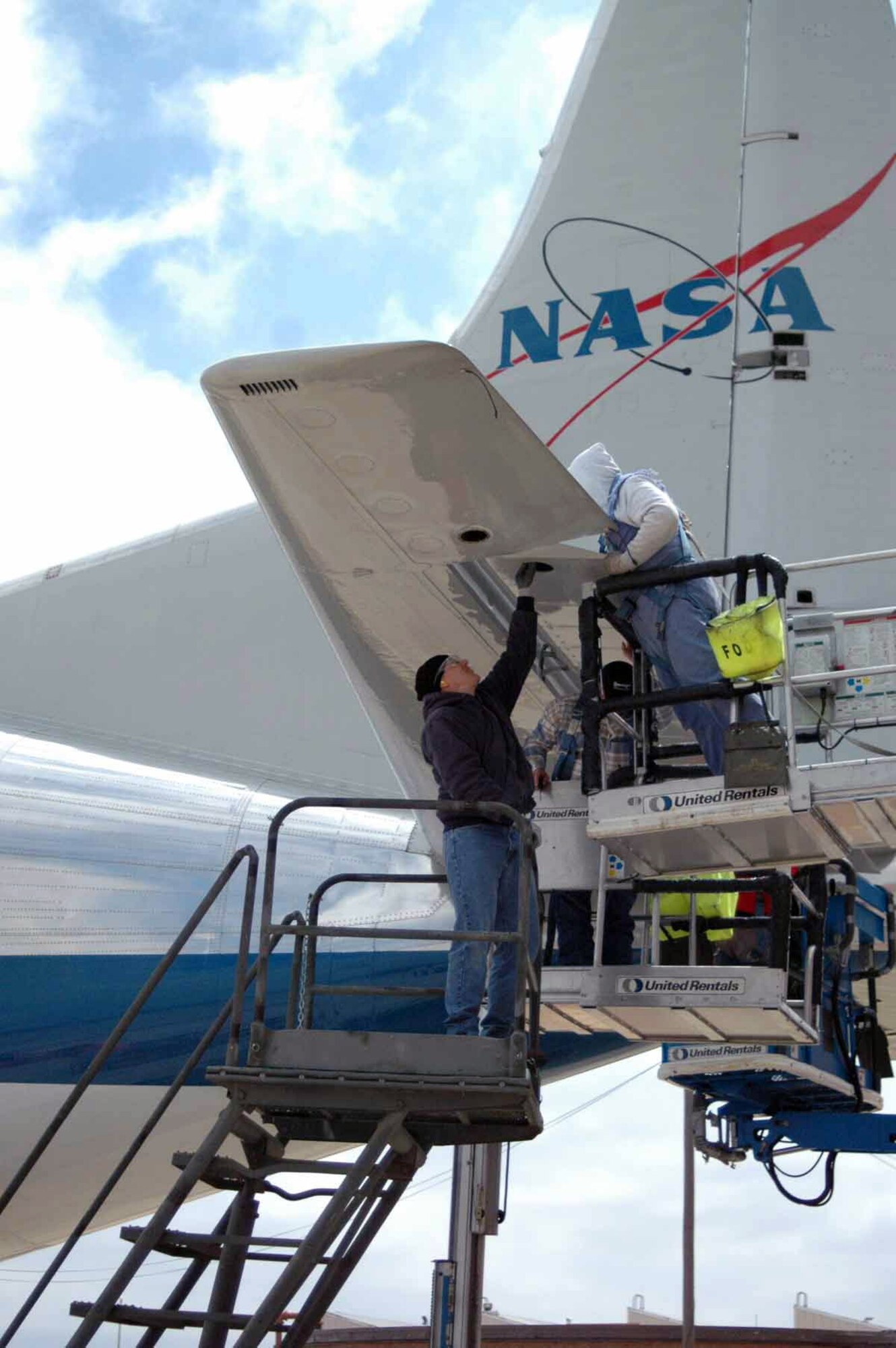 Maintainers at Tinker Air Force Base, Okla., work on an elevator of NASA's Supper Guppy.  NASA officials brought the unique aircraft to Tinker AFB because of the capability of Tinker's workforce to inspect and repair the large aircraft.  (U.S. Air Force photo/Debra Bennett)