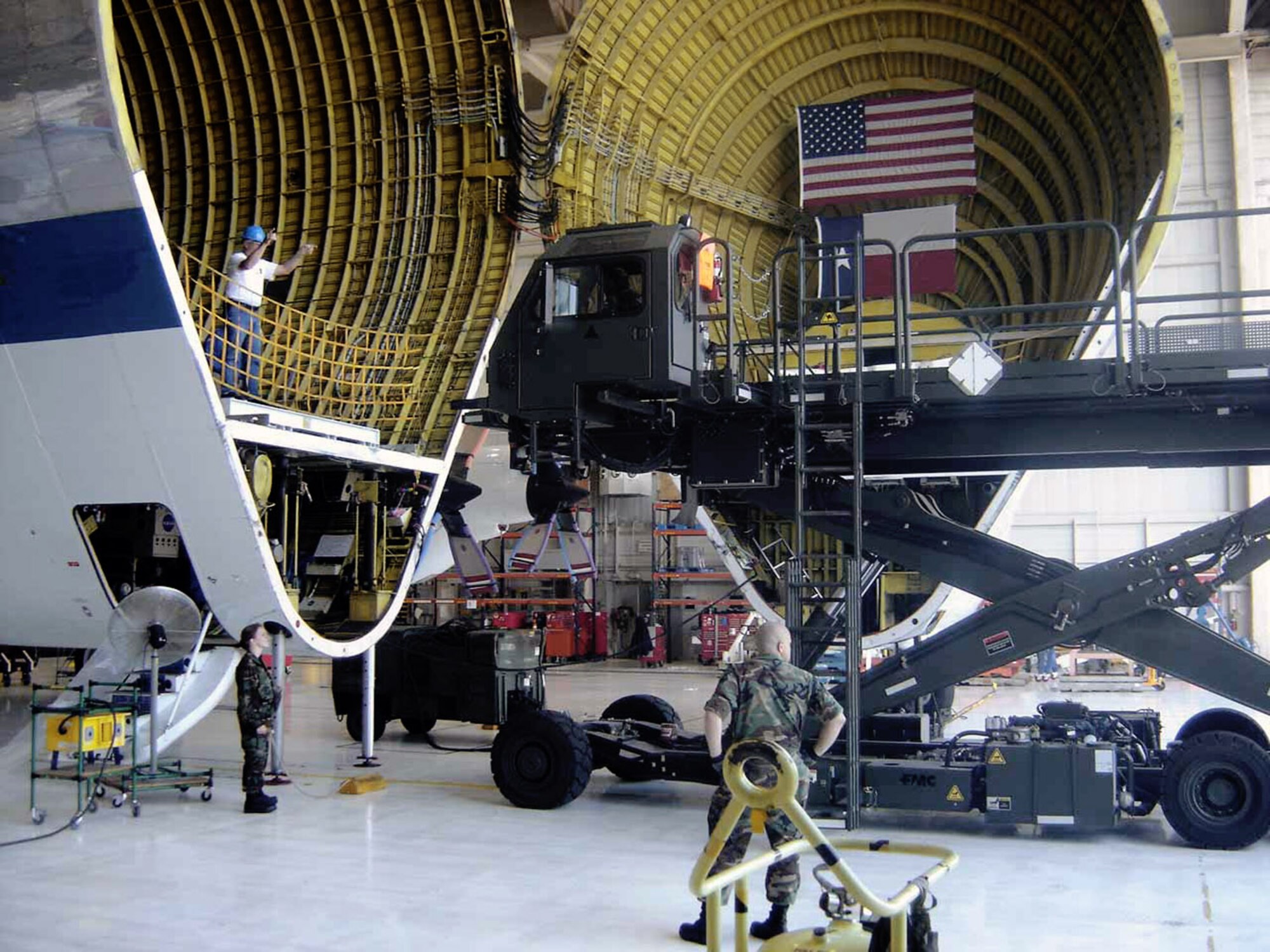 Workers in the 566th Aircraft Maintenance Squadron at Tinker Air Force Base, Okla., prepare to inspect NASA's Super Guppy. Its hinged nose can be opened 110 degrees for cargo loading. NASA officials brought the unique aircraft to Tinker AFB because of the capability of Tinker's workforce to inspect and repair the large aircraft.  (U.S. Air Force photo/Debra Bennett)