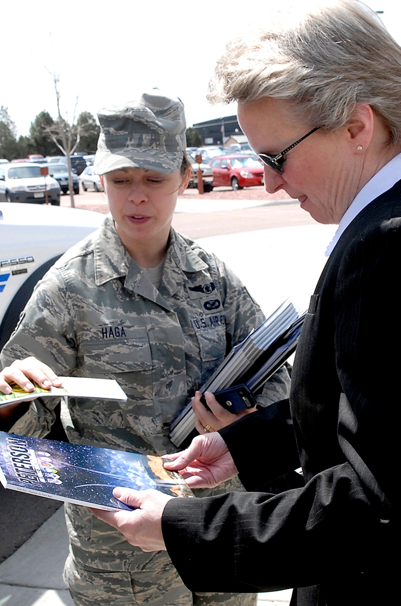 Staff Sgt. Stacey Haga, 21st Space Wing Public Affairs (left), gives an informational base guide to Dr. Penelope Culbreth-Graft April 24 at Peterson Air Force Base, Colo. Dr. Culbreth-Graft, who recently became the new Colorado Springs city manager, was introduced to the base and its mission to gain a better understanding of how the city and Peterson work together. The doctor was also introduced to Peterson’s BluePrint-2050 development plan and was provided a tour of the installation. (U.S. Air Force photo/Rob Bussard)