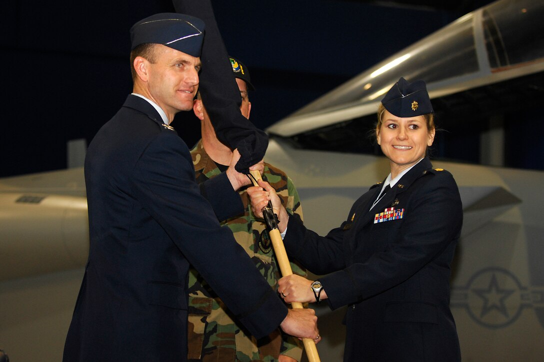 LANGLEY AIR FORCE BASE, Va. -- Col. Brian Yolitz, previous 1st Mission Support Group commander, hands the guidon to Maj. Caroline Miller, previous 1st Mission Support Squadron commander and new 1st Force Support Squadron commander, during the 1st FSS activation ceremony here April 22. The new squadron, totaling 800 people, is a result of the 1st MSS and 1st Services Squadron merger. (U.S. Air Force photo/Airman 1st Class Gul Crockett)