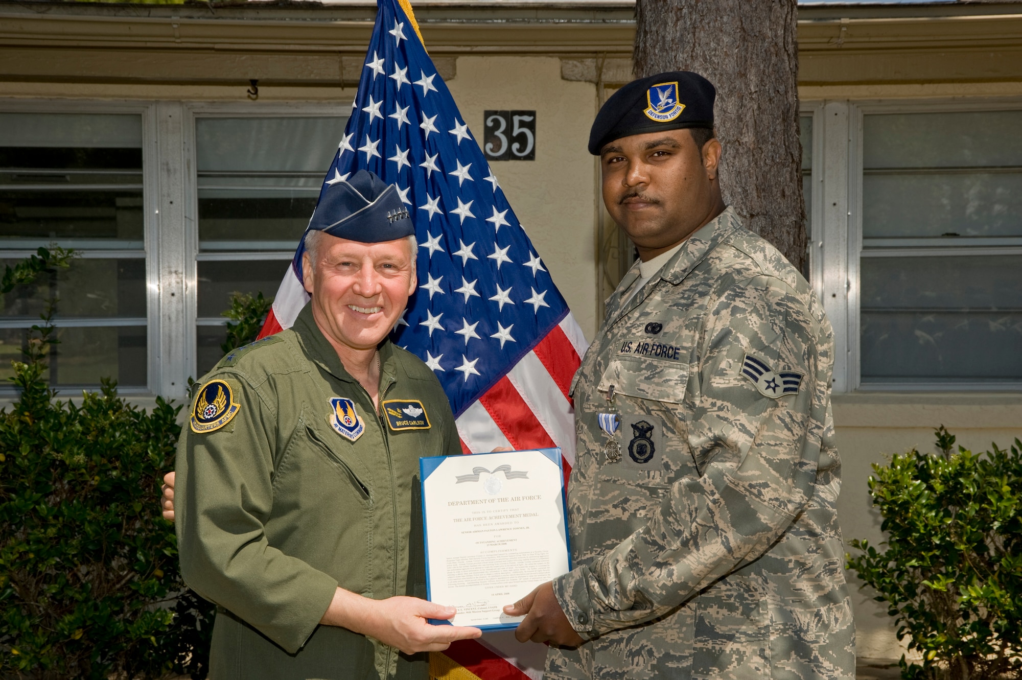 EGLIN AFB, Fla. -- Gen. Bruce Carlson, Air Force Materiel Command commander, presents an Achievement Medal to Senior Airman Payton Townes, 96th Security Forces Squadron.  Airman Townes was instrumental in providing command and control following a credible threat to a dependent. (USAF photo by Greg Murry)