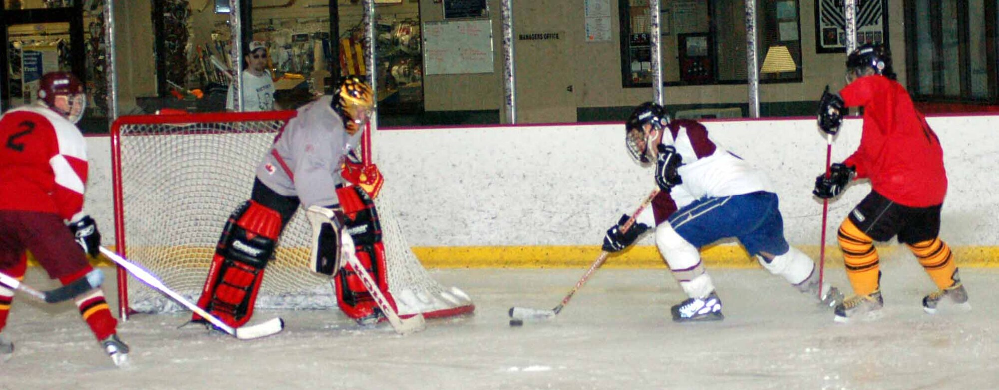 Tinker Hawks defenseman Chris Beatty gathers the puck around the net in a gam against The Storm April 20 at the Blazers Ice Centre.  (Air Force photo by John E. Banks)