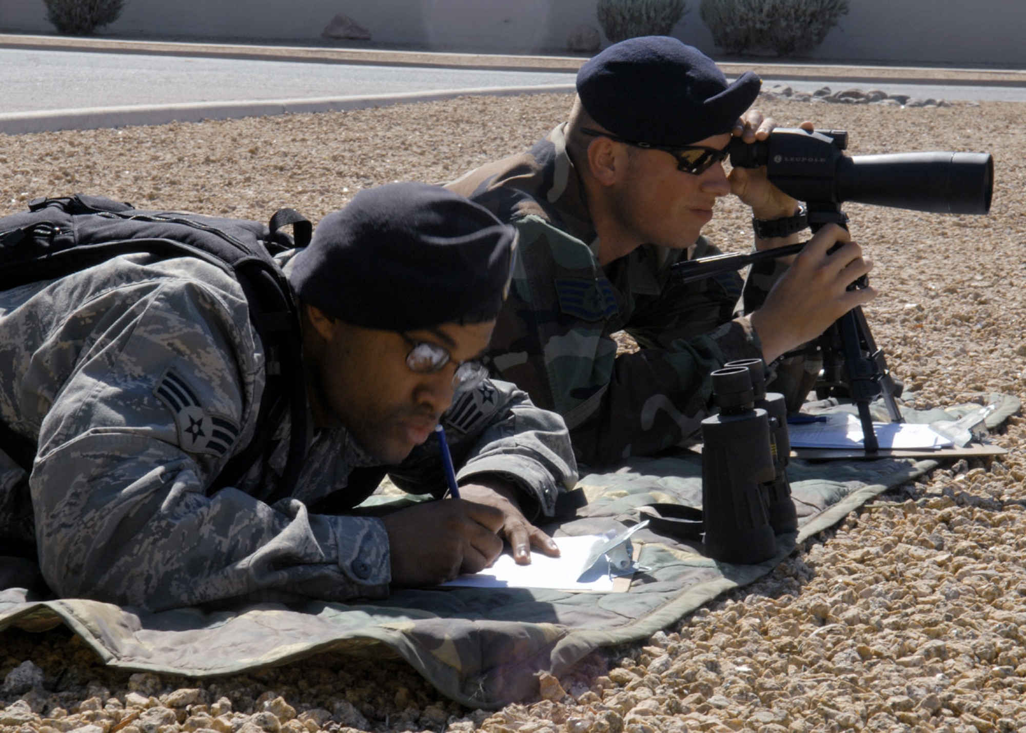Staff Sgt. Anthony Quinn and Senior Airman Benny Prescott train on target detection and sketching to prepare them for close precision engagement training April 3. Target detection and sketching are two kinds of techniques used by sharpshooters and is used to find small objects and potential targets. Sergeant Quinn and Airman Prescott are a patrolmen from the 56th Security Forces Squadron at Luke Air Force Base, Ariz.. (U.S. Air Force photo/Airman 1st Class Gustavo Gonzalez)