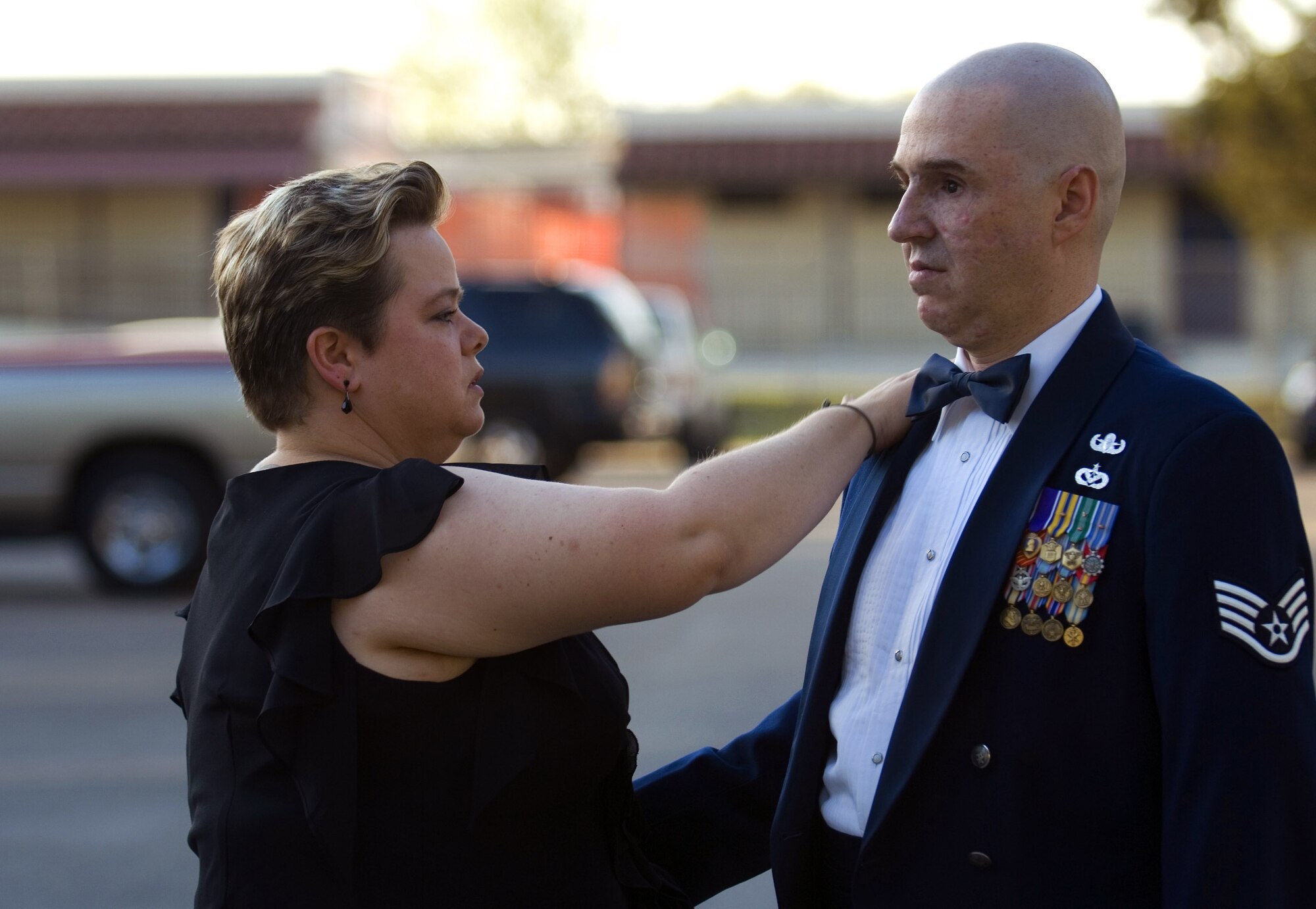 Annette Slaydon adjusts her husband's uniform prior to renewing their marriage vows April 12 at Randolph Air Force Base, Texas. Staff Sgt. Matthew Slaydon was critically wounded by a terrorist bomb in Iraq in October 2007 -- losing his sight, one arm, and suffering multiple facial lacerations and fractures. In addition to Mrs. Slaydon's support to her husband, the Air Force has helped the couple in many ways since Sergeant Slaydon was wounded. (U.S. Air Force photo/Tech. Sgt. Matthew Hannen) 