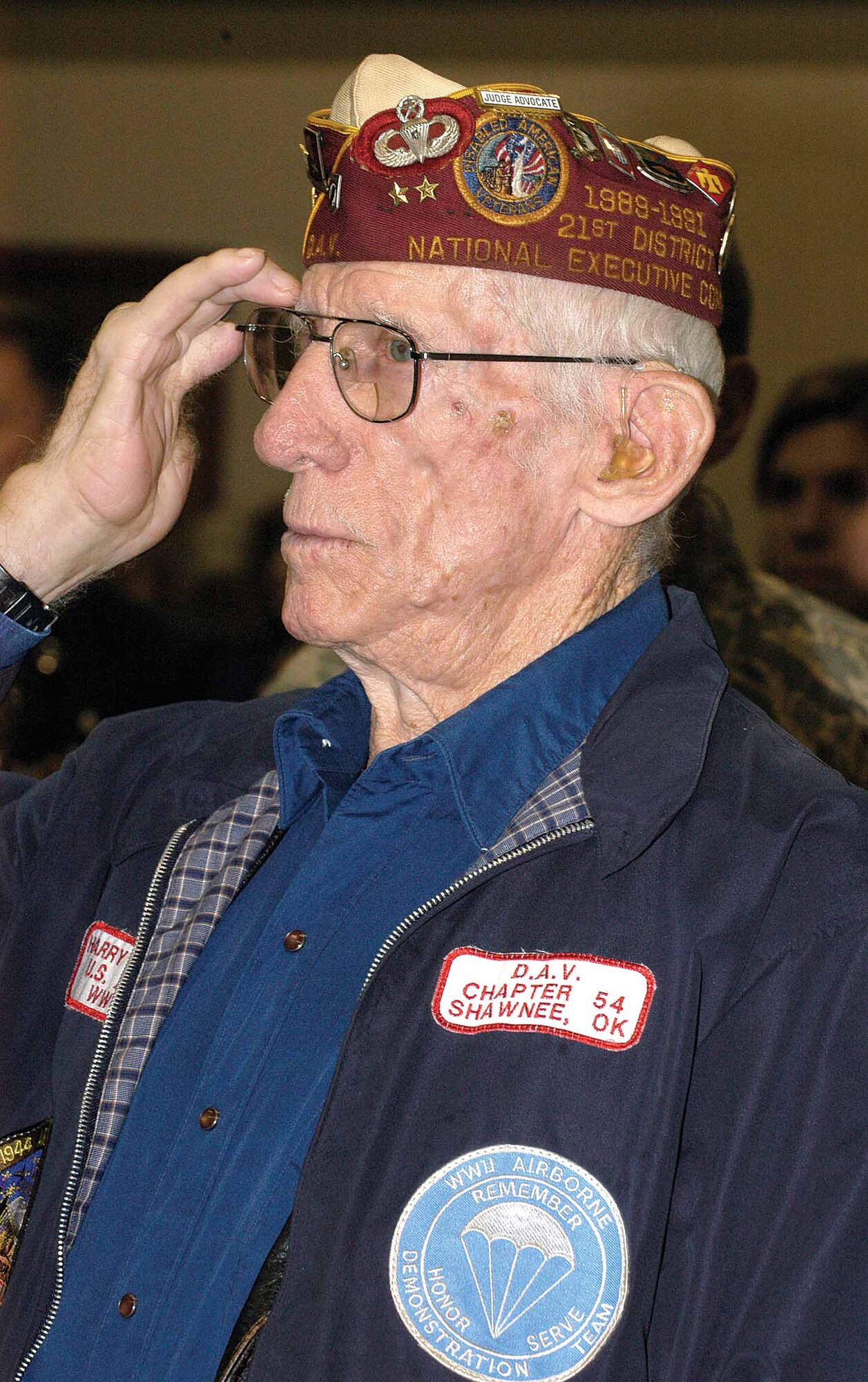 His salute never wavering, World War II Army veteran and ex-prisoner of war Harry Hoots honors the flag during Ex-POW Recognition Day opening ceremonies at the Veterans Administration Medical Center in Oklahoma City.  The 101st Airborne veteran’s hands were severely injured by an enemy hand grenade during the Normandy invasion D-Day battle.  Imprisoned in a German hospital for three weeks, Mr. Hoots told of dropping 65 pounds being fed only two cups of sauerkraut juice a day and having German SS forces severing his injured fingers one joint at a time. (Air Force photos by Margo Wright)
