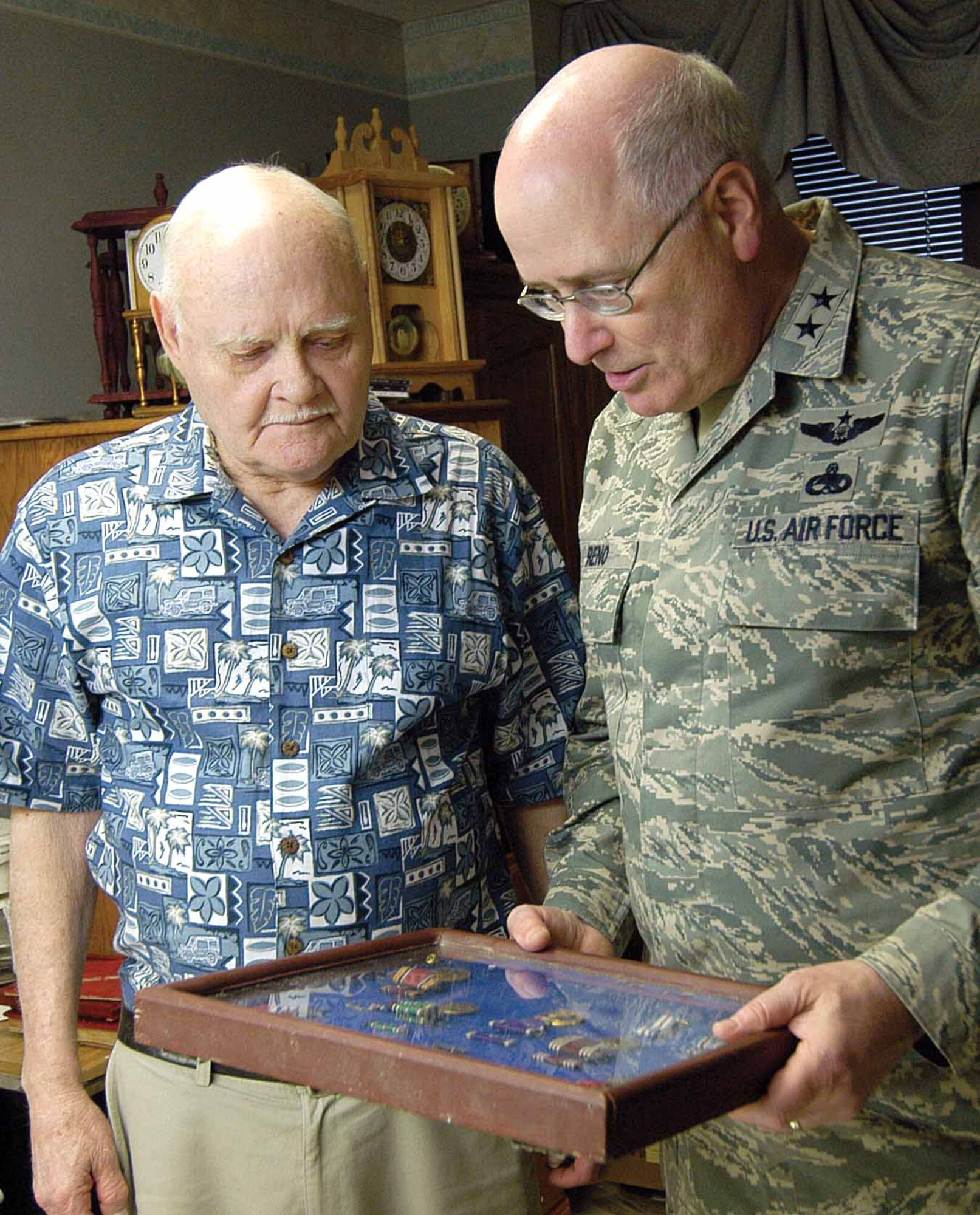 In the privacy of his hospital room, Army veteran Floyd Warren shares his shadow box of military medals with Maj. Gen. Loren Reno.  Two Purple Hearts, a Bronze Star and a Silver Star rest behind glass, prized possessions for the Veterans Administration Medical Center resident visited by the Oklahoma City Air Logistics Center commander.  General Reno was the facility’s guest speaker for an April 9 Ex-POW Recognition Day event and then joined other military members to visit hospitalized veterans after the official ceremony.   (Air Force photo by Margo Wright)
