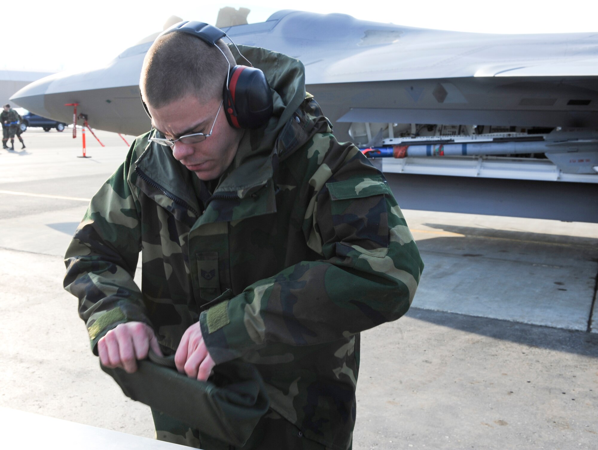 Staff Sgt. Micheal Wilson, a 525th Aircraft Maintenance Unit weapons loader, looks through his tools in his tool sleeve during the Load Crew Competition April 18. (U.S. Air Force photo by Airman 1st Class Matt Owens)
