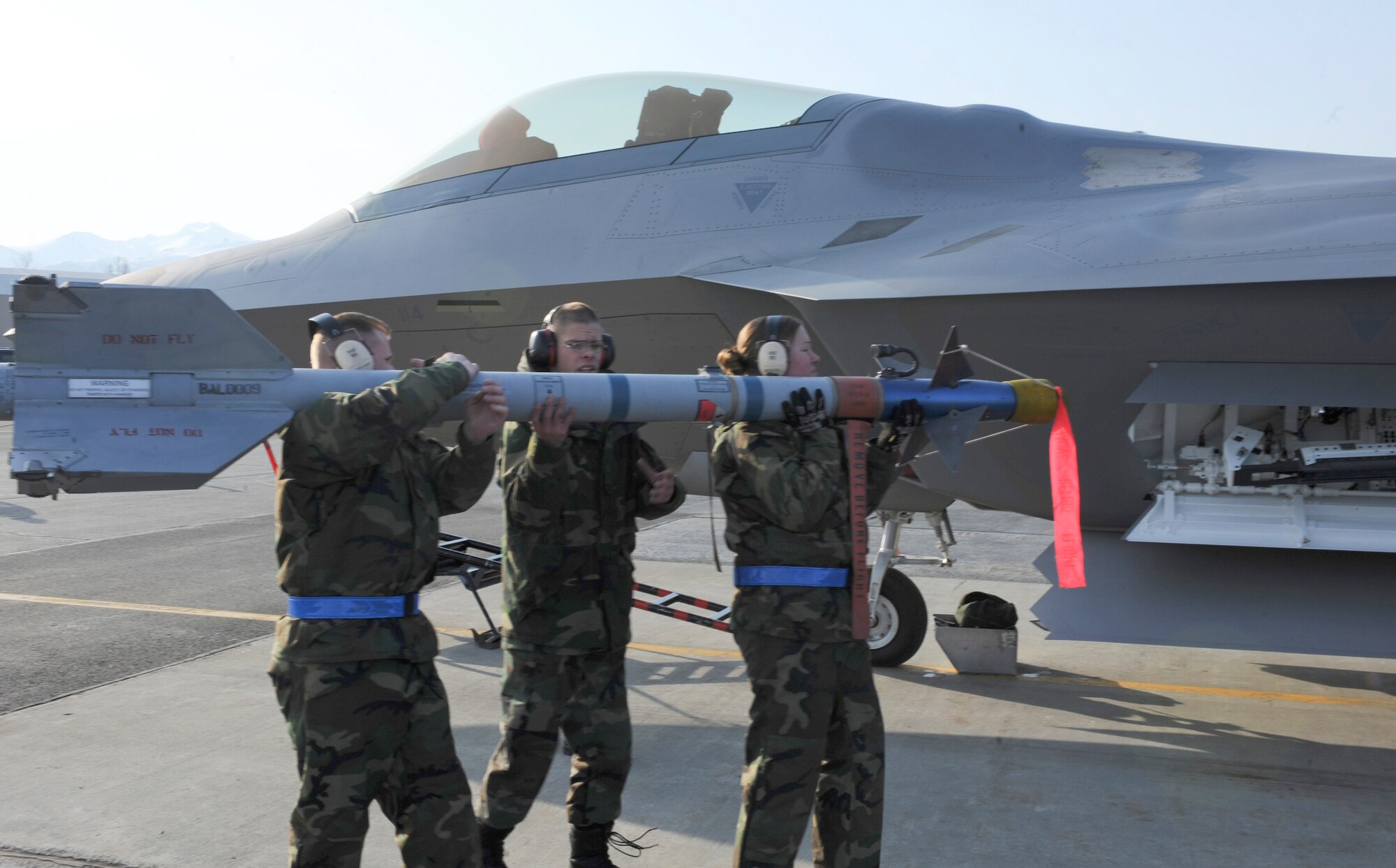 The 525th Aircraft Maintenance Unit load crew 1 carry an F-22A Raptor weapon to the side weapon bay during the Load Crew Competition April 18. The 525th AMU load crew one won the Load Crew Competition. This competition was the load crew's first since the fighter squadron's activation Oct. 29, 2007. (U.S. Air Force photo by Airman 1st Class Matt Owens)