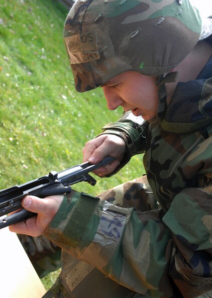 Airman 1st Class Michael Van Bogaert assembles an M-16 at the last stop in a relay race at the ability to survive and operate rodeo during Operation Saber Crown 08-06 April 23. Participants in the relay race demonstrated the rush and roll, prone position, high-crawl, low-crawl and assembling and disassembling the M-16. Airman Van Bogaert is assigned to the 52nd Civil Engineer Squadron. (U.S. Air Force photo/ Airman 1st Class Jenifer Calhoun) 