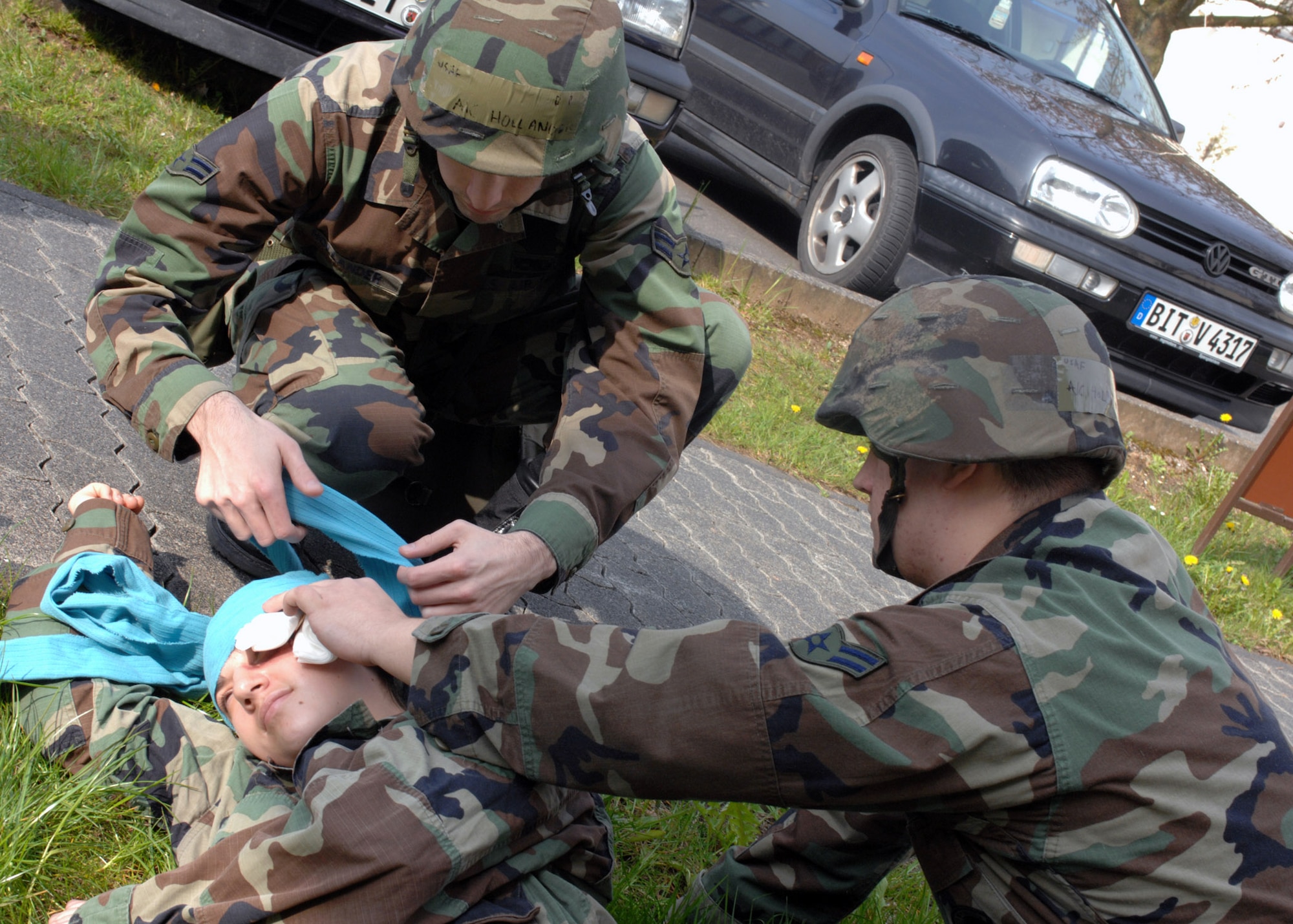 Airman 1st Class Johnathan Hollander and Airman 1st Class Justin Holmes,  assist a victim during Operation Saber Crown 08-06 April 22. Airmen Hollander and Holmes are both from the 52nd Maintenance Operations Squadron. (U.S. Air Force photo/Airman 1st Class Jenifer Calhoun) 