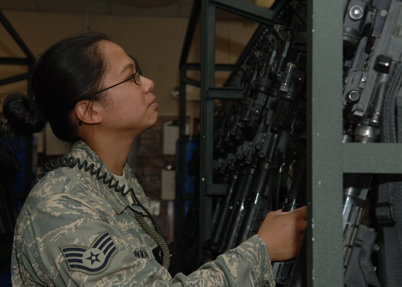 DYESS AIR FORCE BASE, Texas -- Staff Sergeant Suzette Workman, 7 Security Forces Squadron, must inspect every weapon before she issues it out and after it is returned, April 22. These inspections are done to ensure the weapon has its safety on, cleared and functions properly.  (U.S. Air Force Photo by Airman 1st Class Micheal Breaux)