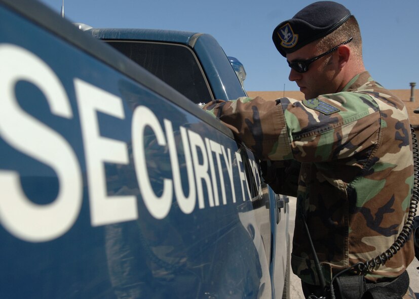 DYESS AIR FORCE BASE, Texas -- Senior Airman Justin Smith, 7 Security Forces Squadron, finishes issuing a ticket April 22. (U.S. Air Force Photo by Airman 1st Class Micheal Breaux)