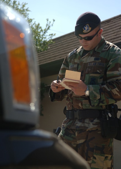 DYESS AIR FORCE BASE, Texas -- Senior Airman Justin Smith, 7 Security Forces Squadron, issues a ticket for a parking violation April 22. (U.S. Air Force Photo by Airman 1st Class Micheal Breaux)