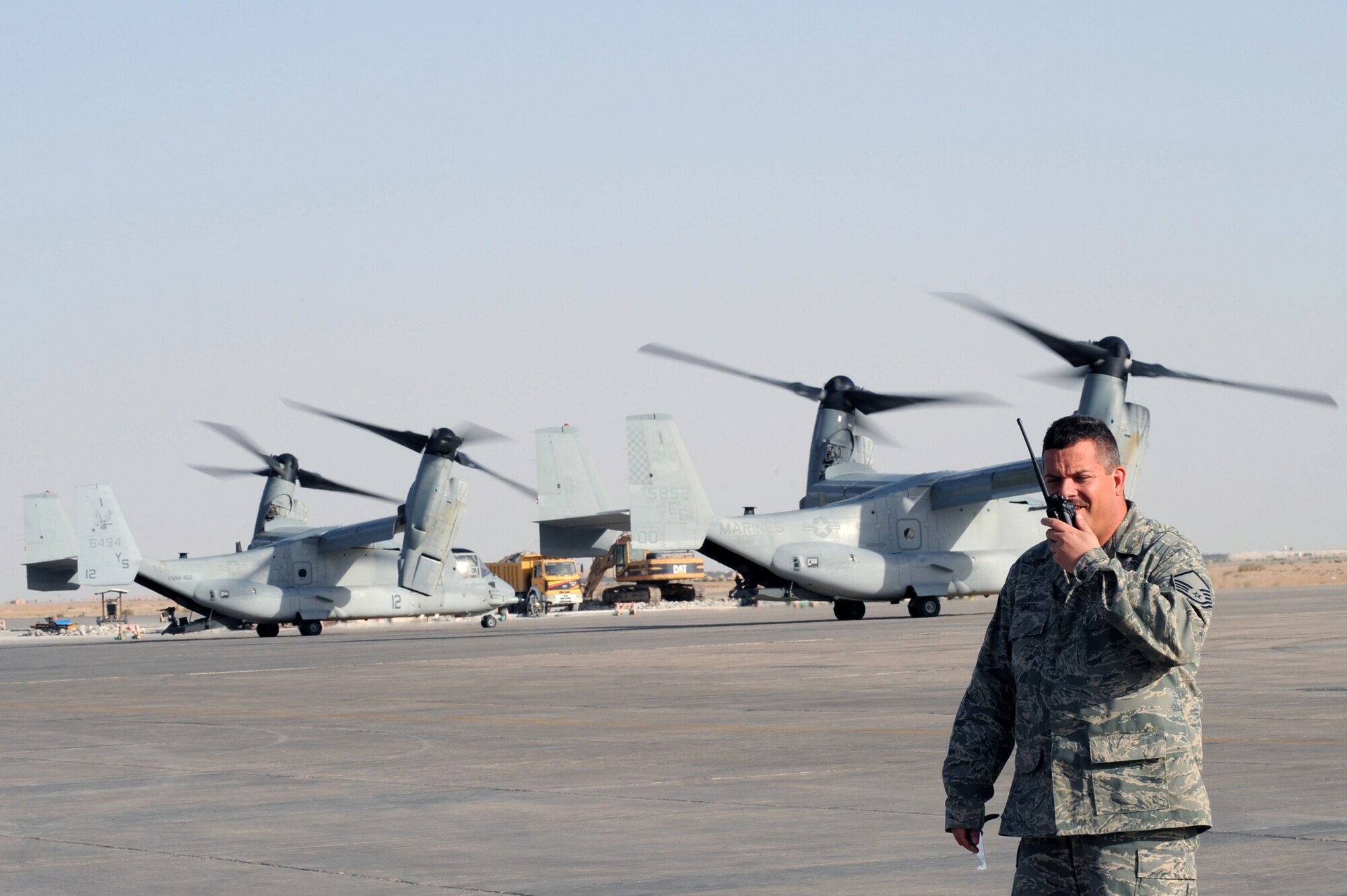 ALI BASE, Iraq -- Master Sgt. Matthew Smith, 407th Expeditionary Operations Squadron airfield manager, keeps in contact with the Air Traffic Control during the takeoff of two, V-22 Osprey's here April 24.  The V-22 Osprey is an aircraft used to transport Airmen, Troops, and cargo.  Sergeant Smith is deployed from McConnell AFB, Kan. (U. S. Air Force photo / Tech. Sgt. Sabrina Johnson)
