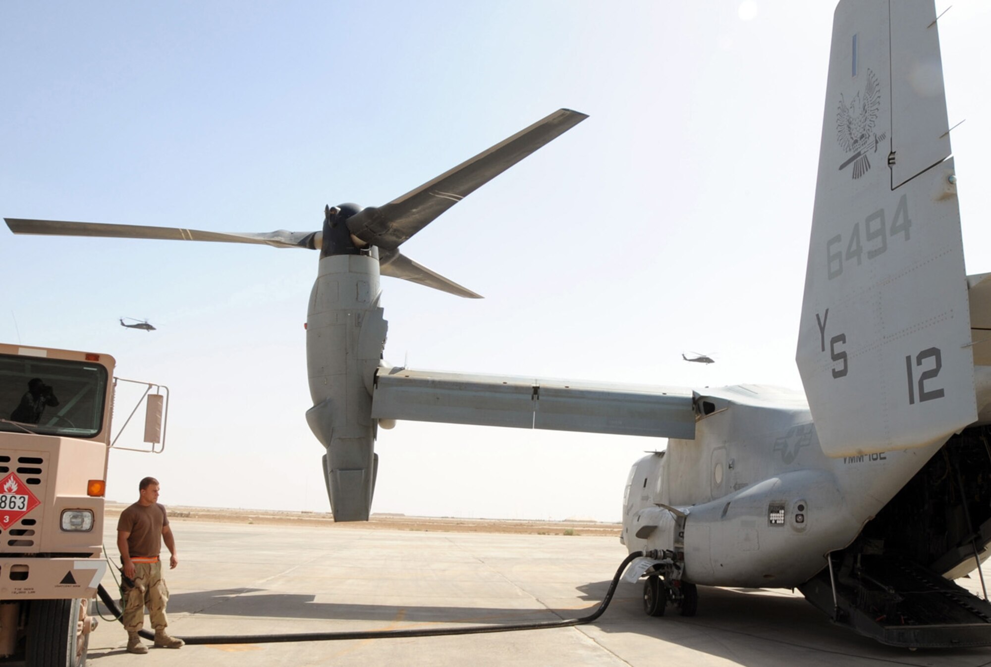 ALI BASE, Iraq -- Senior Airman Matthew Lawson, 407th Expeditionary Logistics Readiness Squadron refueling unit operator, refuels a V-22 Osprey here April 24.  The Petroleum, Oil and Lubricants section refuels various cargo aircraft from around the Area of Responsibility.  Airman Lawson is deployed from Ramstein Air Base, Germany.  (U. S. Air Force photo / Tech. Sgt. Sabrina Johnson)