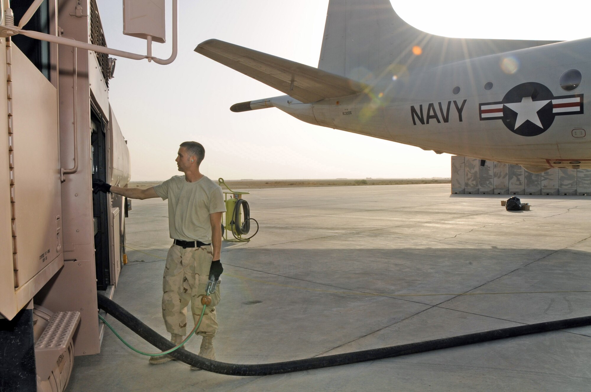 Airman 1st Class Christopher Carbon refuels a Navy P-3 Orion April 23 at Ali Base, Iraq. Airman Carbon, a 407th Expeditionary Logistics Readiness Squadron refueling unit operator, has pumped more than 1.2 million gallons of gasoline since arriving at Ali Base in January.  The Petroleum, Oil and Lubricants section refuels Navy P-3s, MQ-1 Predators, helicopters and various cargo aircraft to support the mission in Southwest Asia.  Airman Carbon is deployed from Ramstein Air Base, Germany. (U.S. Air Force photo/Tech. Sgt. Sabrina Johnson)