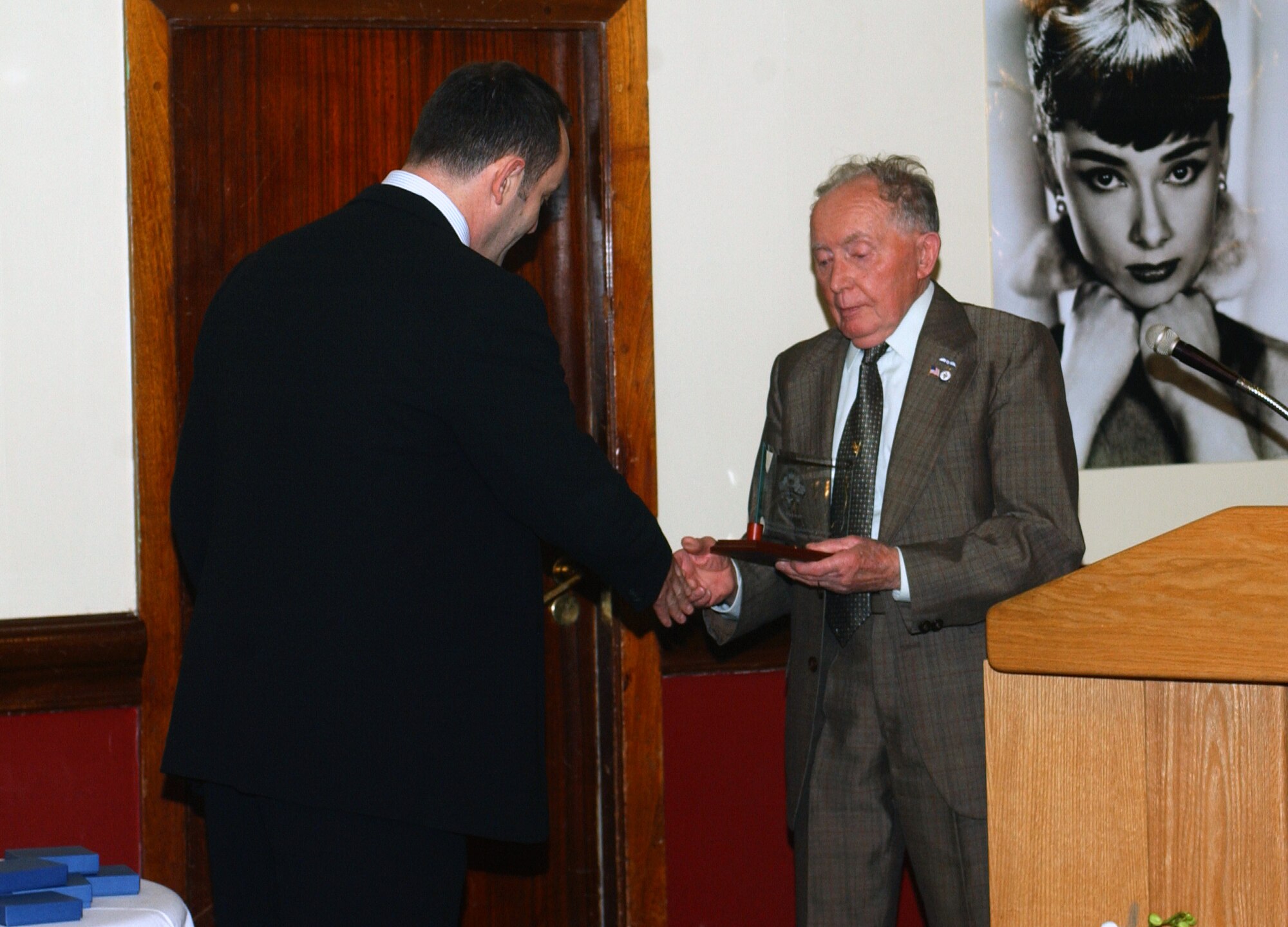 Collin Wills, 48th Fighter Wing honorary commander presents Doug Warwick, community tour coordinator with the British-American Committee Outstanding Award during the "Rock the Red Carpet" dinner April 18 at the Eagle's Landing, RAF Lakenheath, England. The dinner was a combination of the OCSC’s annual British-American social and the BAC's community award ceremony.