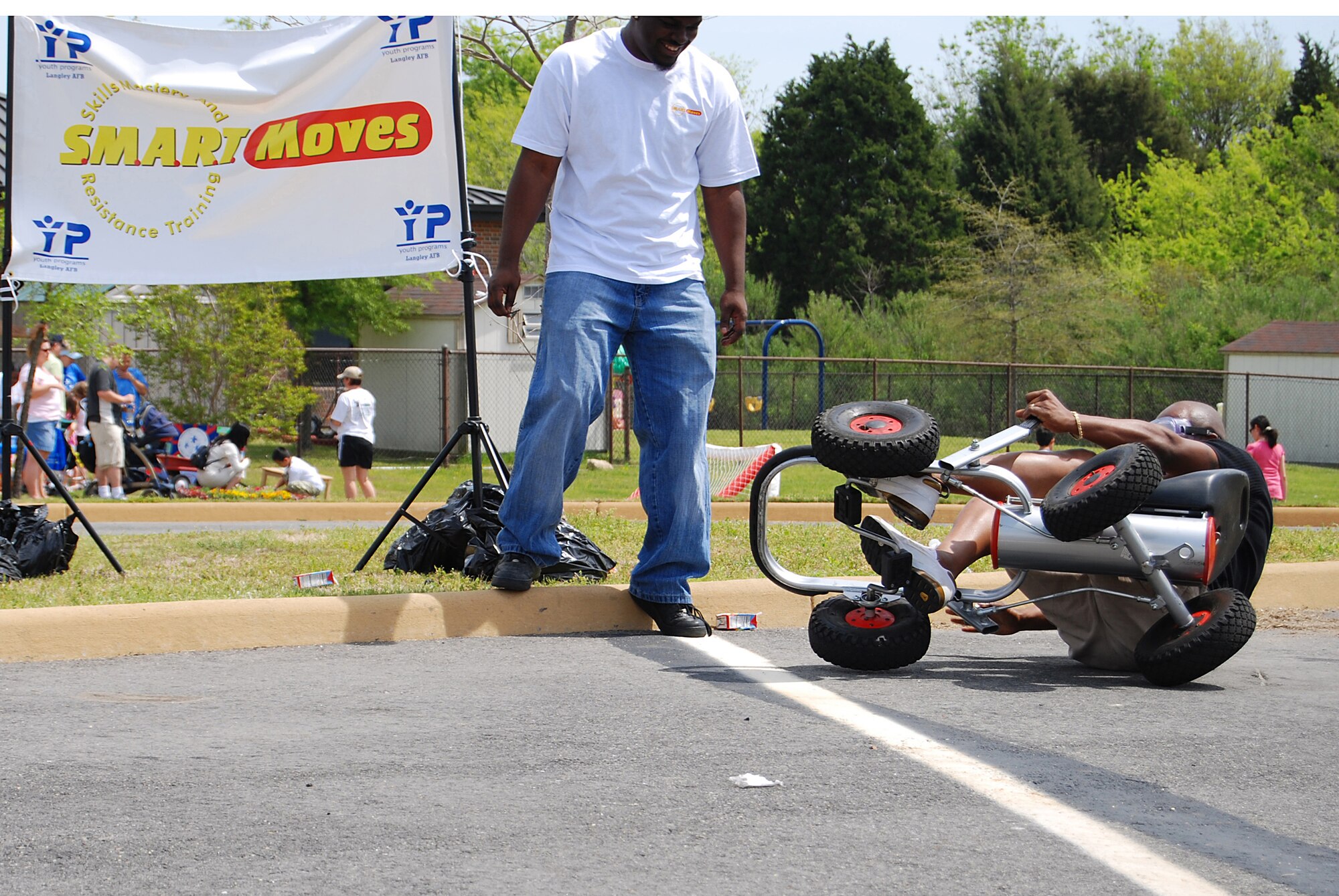 LANGLEY AIR FORCE BASE, Va. -- Mr. Roland Taylor, 1st Force Support Squadron family member program chief, crashes while wearing impairment goggles at KidsFest here April 19. The race track was part of the Skills Mastery and Resistance Training, or SMART Moves prevention and education program, which addresses problems such as drug and alcohol use. More than 800 children and adults attended this year's Kidfest, an annual celetration honoring military children and their families with games, prizes, food and entertainment. (U.S. Air Force photo/Staff Sgt. Misty D. Slater)
