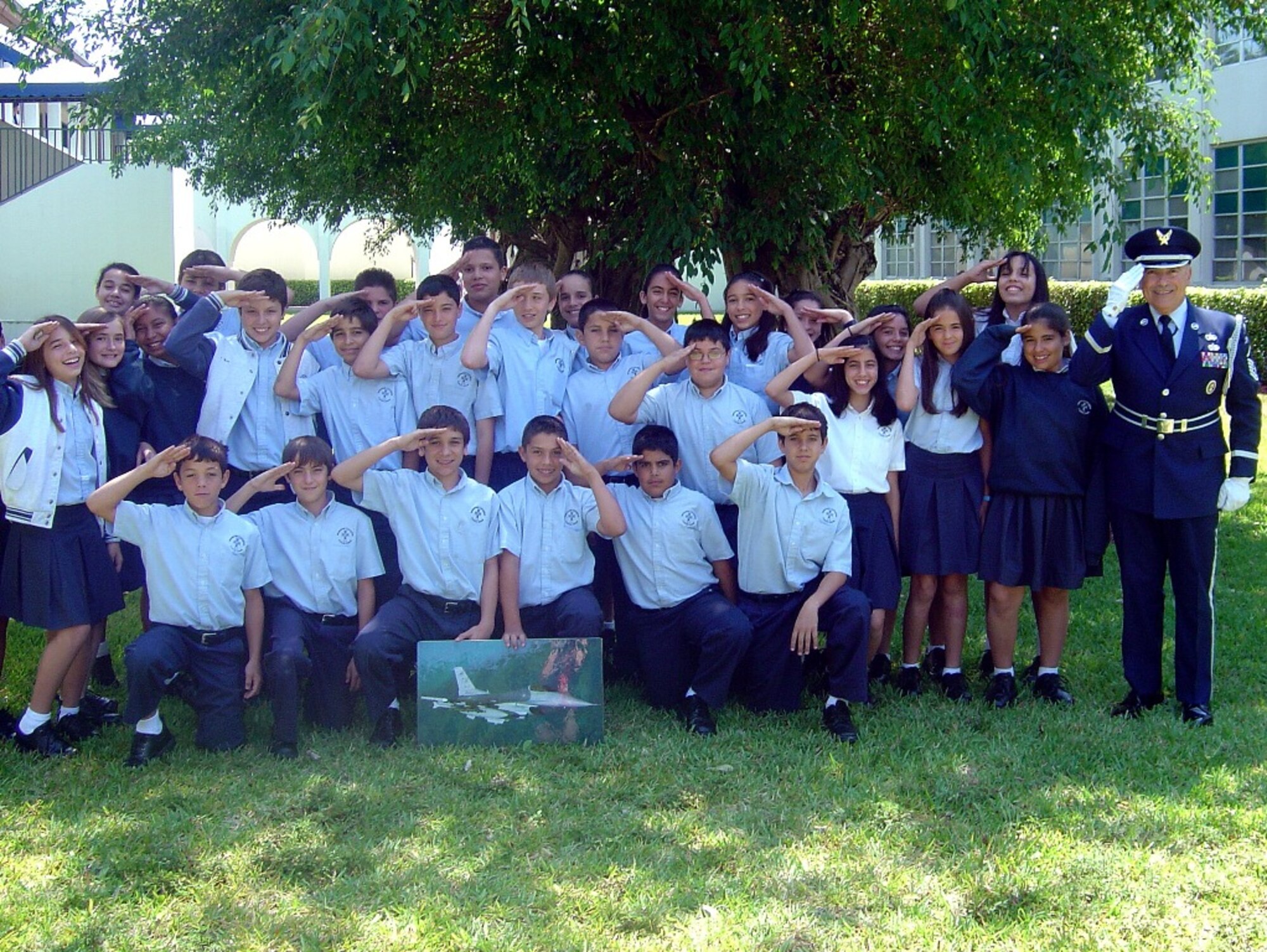 Master Sgt. Richard Rios, 482nd Communications Squadron senior air reserve technician, salutes with children from the Immaculate Conception Catholic School in Hialeah during “Career Day” on April 22. Each year, the City of Hialeah resident uses personal leave time to represent the Air Force Reserve during career days at public and private schools in the Hialeah area. Sergeant Rios talked about his job and the Air Force, and he explained the meaning of the American Flag. (Courtesy photo)
