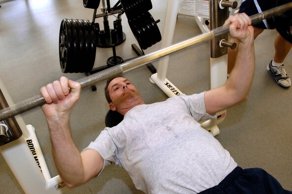 HANSCOM AFB, Mass. – Tech. Sgt. Mike Dodge, noncommissioned officer in charge, Hanscom 3A0 Training, bench presses at the Fitness and Sports Center here. Sergeant Dodge, who used the Health and Wellness Center’s Tobacco Cessation “Kicking Butts” program, quit smoking August of last year. Since quitting, the sergeant has noticed improvements in both his physical and mental health. (U.S. Air Force photo by Mark Wyatt.)