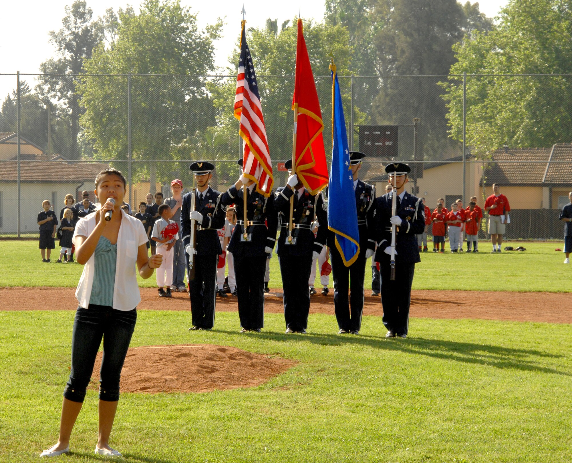 Reanne Acasio, winner of the 2008 USAFE Youth Talent Contest at incirlik, sings the National Anthem at the Incirlik Youth Baseball League opening ceremony April. There are 13 teams in the league rangng from 5-6 year olds in tee ball to 12-14 year olds in the majors. (U.S Air Force photo by Senior Airman Heather Stanton)